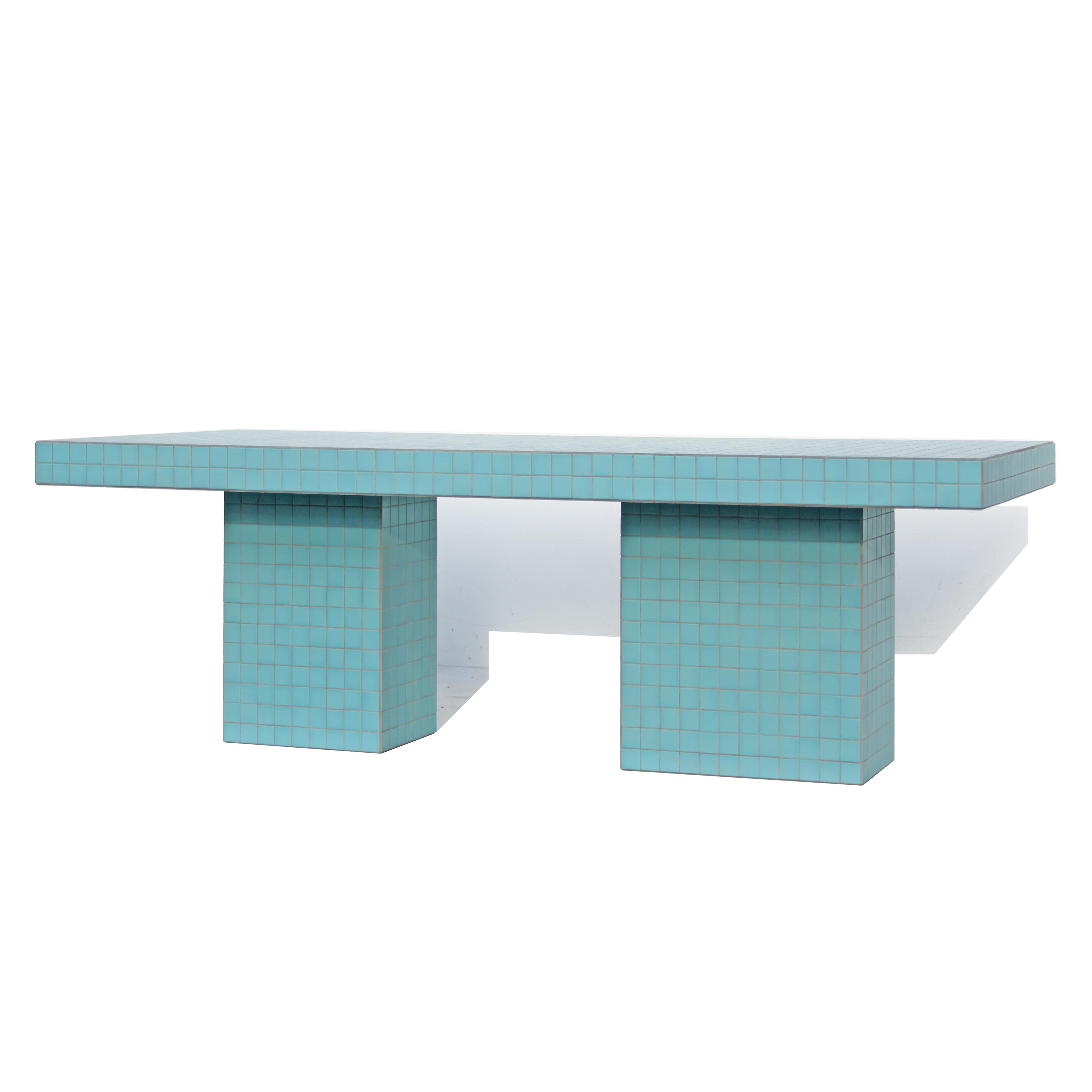 Designed and made by Nima Abili in Los Angeles this handcrafted table is cladded with ocean blue matte porcelain tiles and sanded grey grout. Inspired by Brutalist style of architecture this collection offers a variety of pieces designed based on
