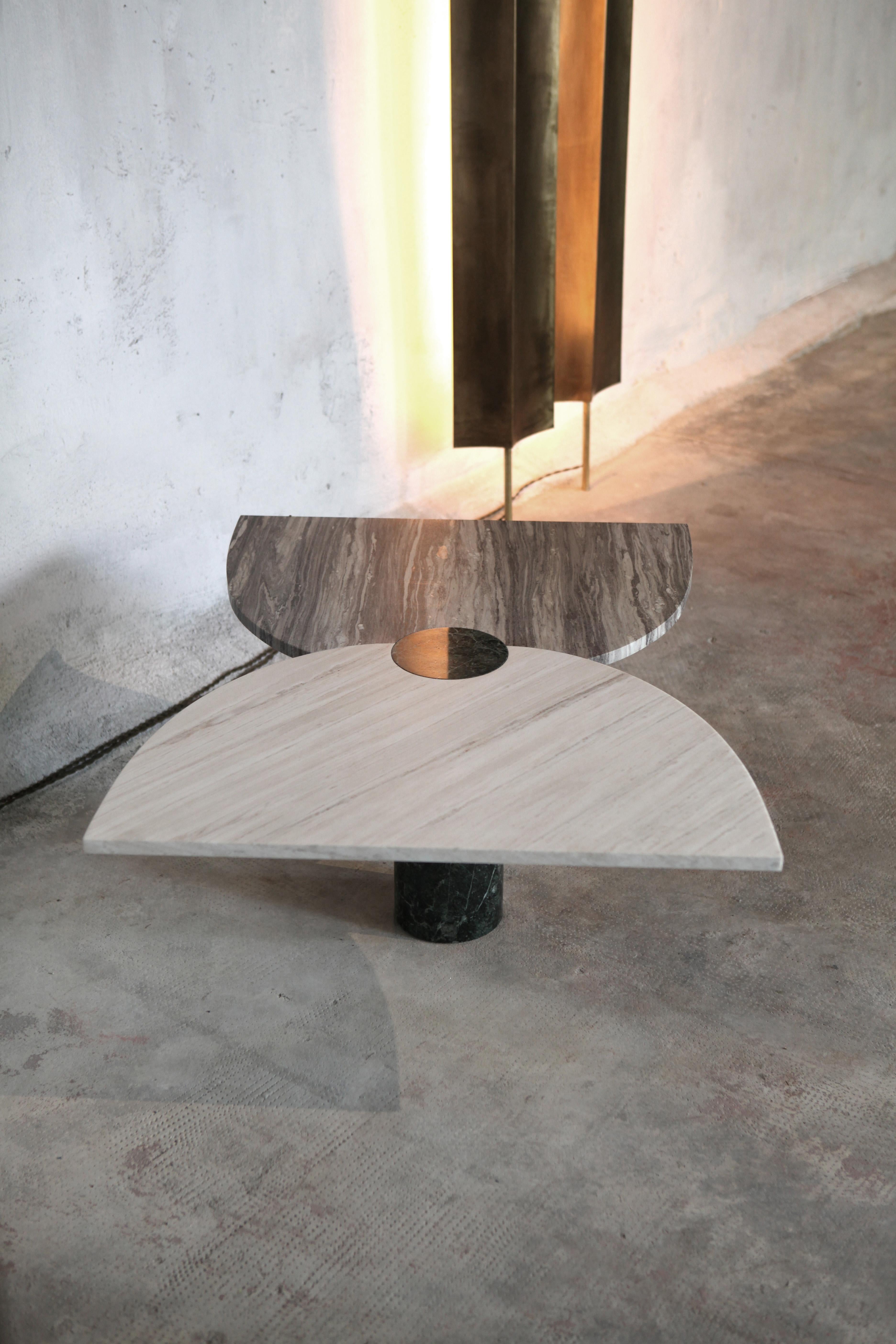 The T_tea coffee table is characterized by the interplay between tree different marbles: two tones of Palissandro marble form the top, while the base is a cylinder of Green Imperial marble. With its simple geometry the T_tea coffee table highlights