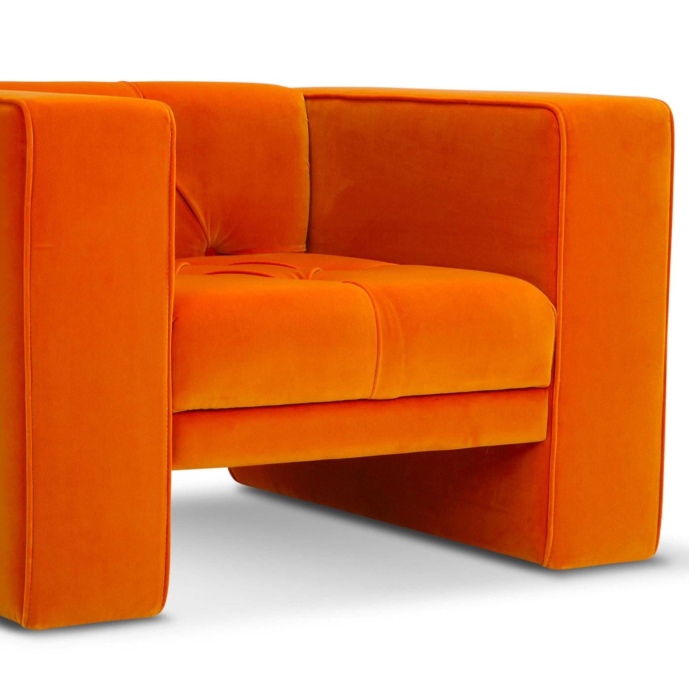 Generously sized and bold, this armchair is effortless in its simplicity, boasting a comfortable, multi-density polyurethane padding that supports the modern, linear silhouette upholstered in vibrant orange Dacron. Seat and back cushions form an