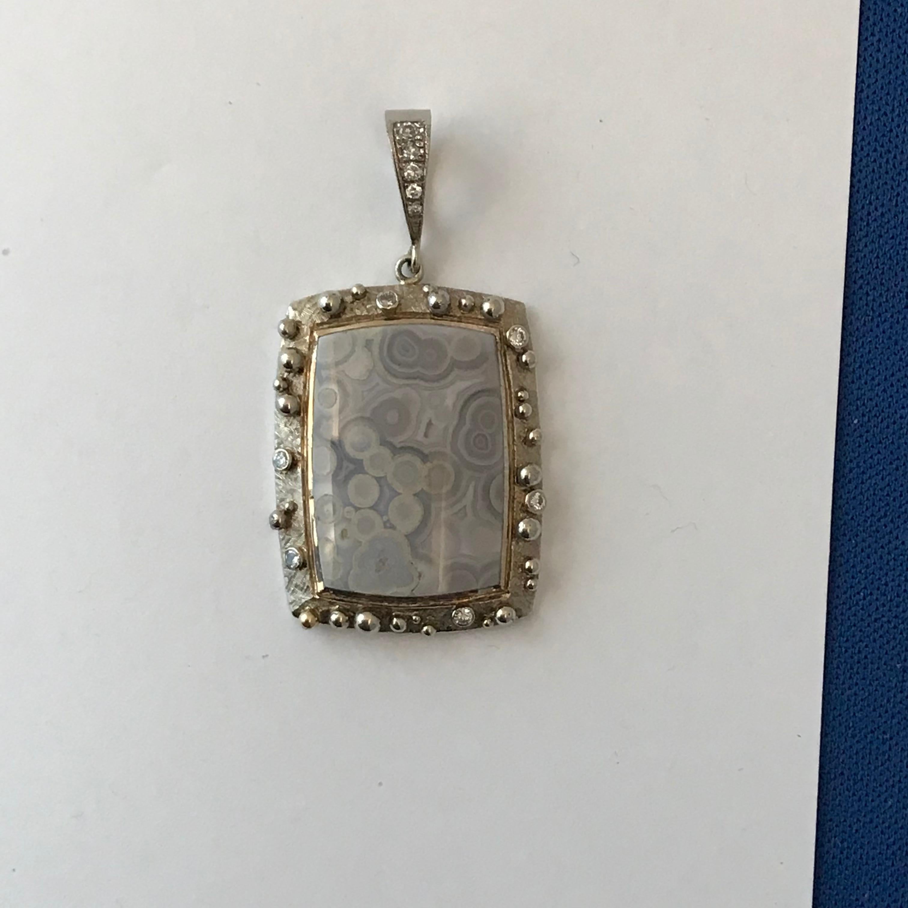 Tube Agate Pendant With .21 Carats Diamonds in 14 K White Gold

This pendant is made from 14k white gold and features a Grey Tube Agate . Diamonds are .21 cts total weight. It is 100% natural in color nothing about it has been changed. Nature does