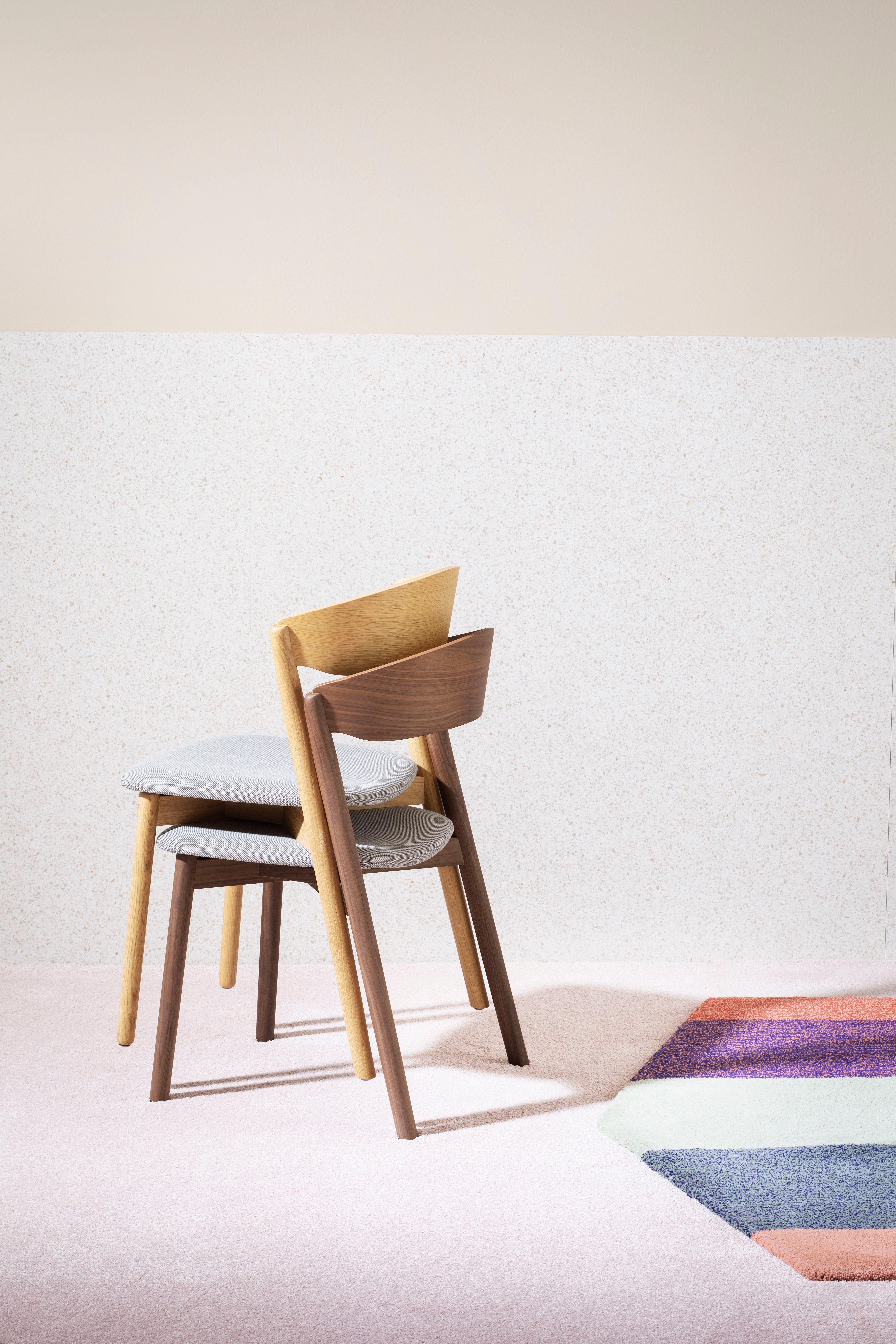 Esta silla tubular está disponible con estructura de madera Canaletto y asiento tapizado en las telas que se indican. La silla tubo también está disponible en haya y madera maciza de roble.

Cristiana Giopato y Christopher Coombes llevan