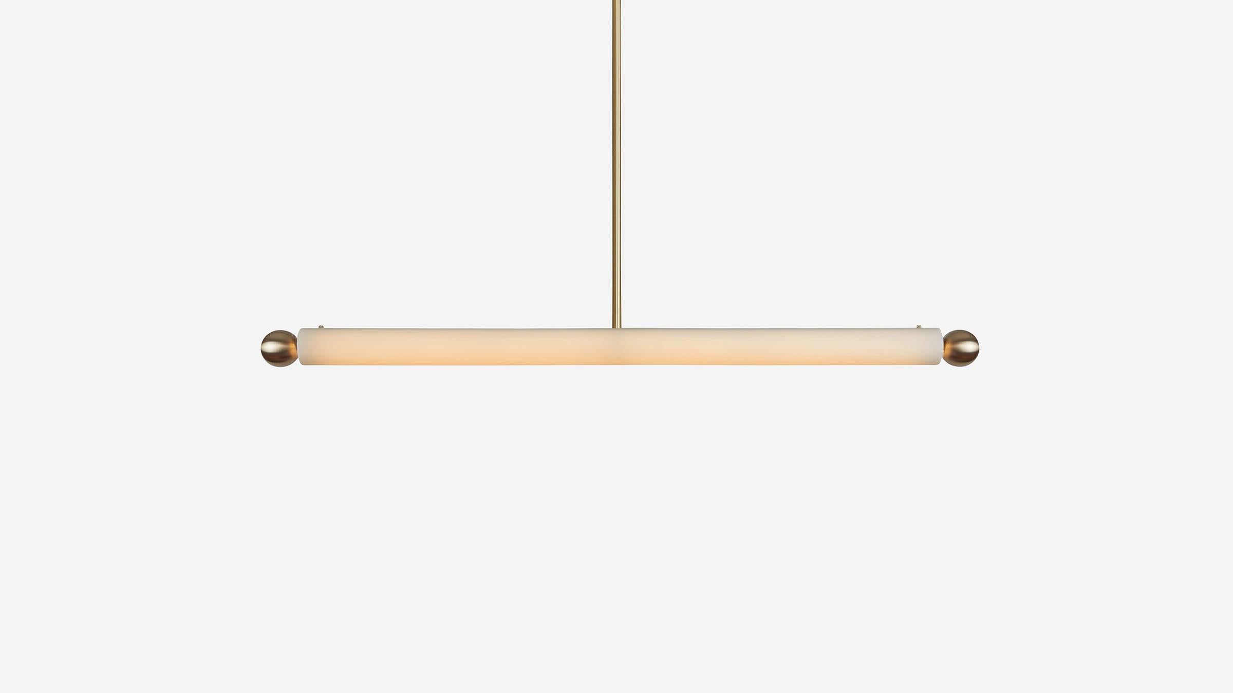 TUBE PENDANT XL stretches the bright light of the TUBE collection even further in order to illuminate longer expanses. Matte blown-glass is punctuated on either side by two metal balls creating contrasting focal points. Custom Heights Available.