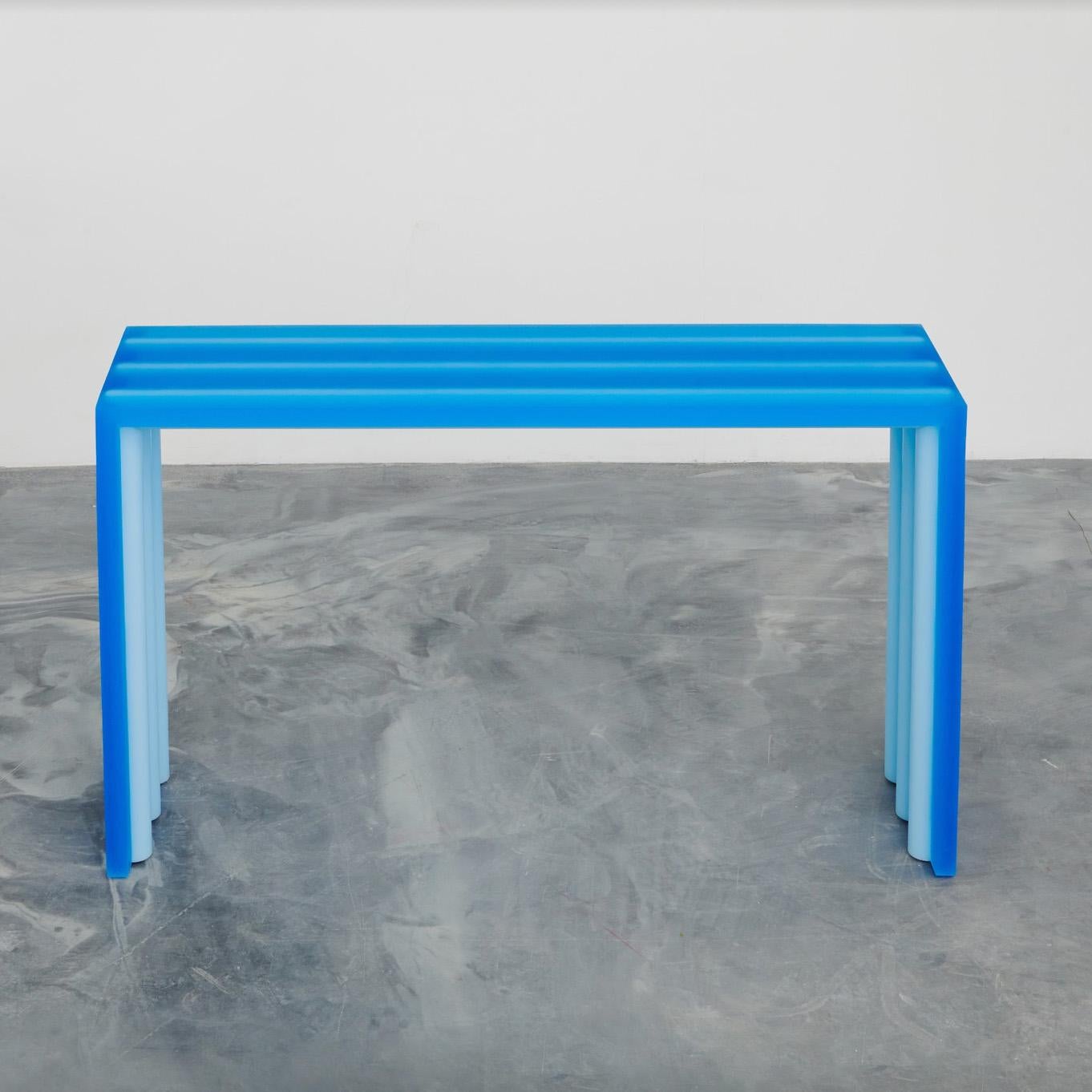 Inspired by the first facture blue console, the tube console has transparent blue resin around a light blue core but in this iteration the core cuts through the resin slab, physically sinking into the transparent outside and pushing through on the