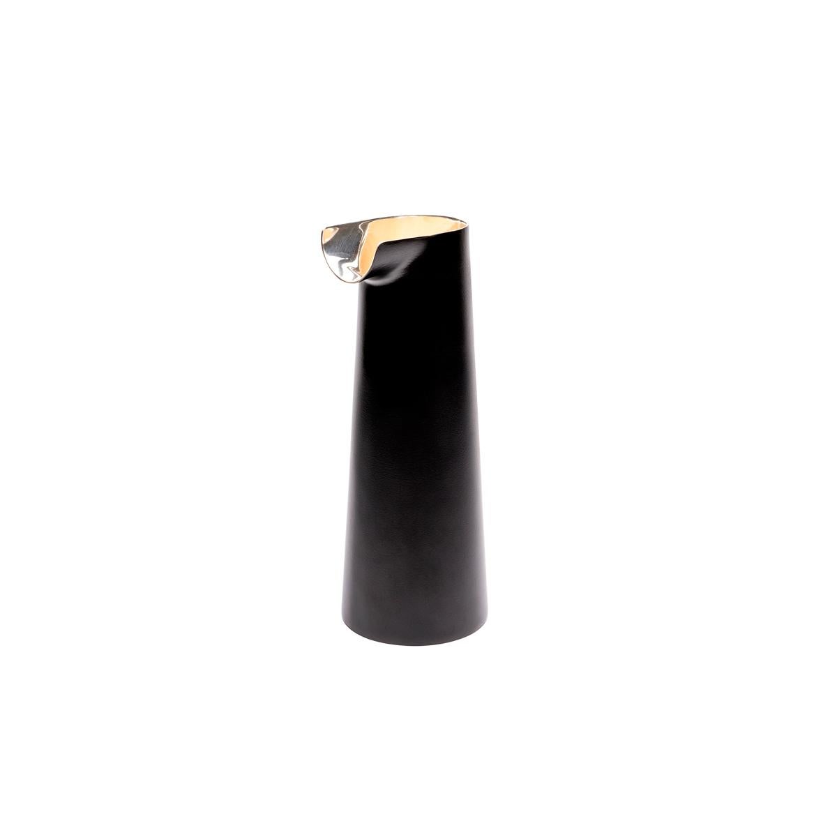 Tube is a silver plated jug available in two different finishes: only silver-plated metal, or silver plated metal with a black external finishing. This item was designed by the Italian designer duo Zaven, who took their inspiration from a small