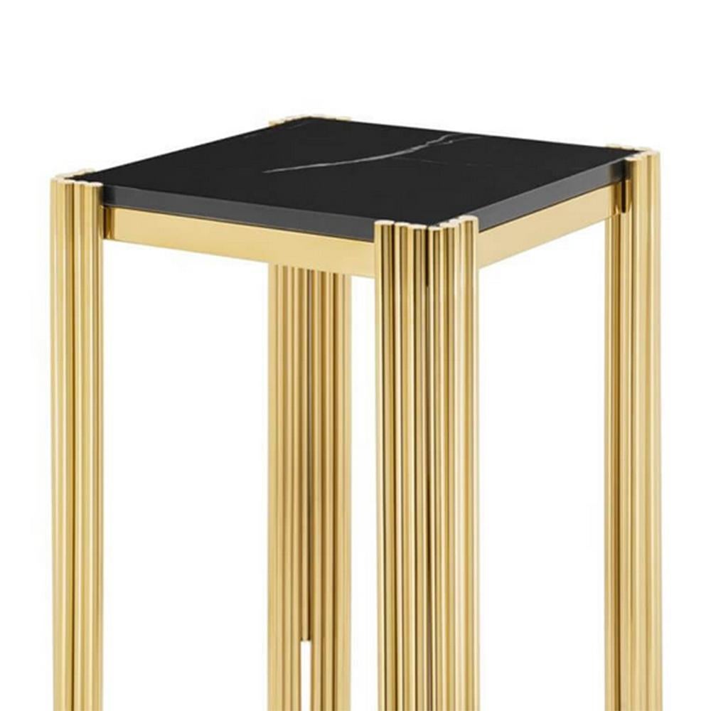 Side table tubes II high with structure in
steel in gold finish and with black marble top.