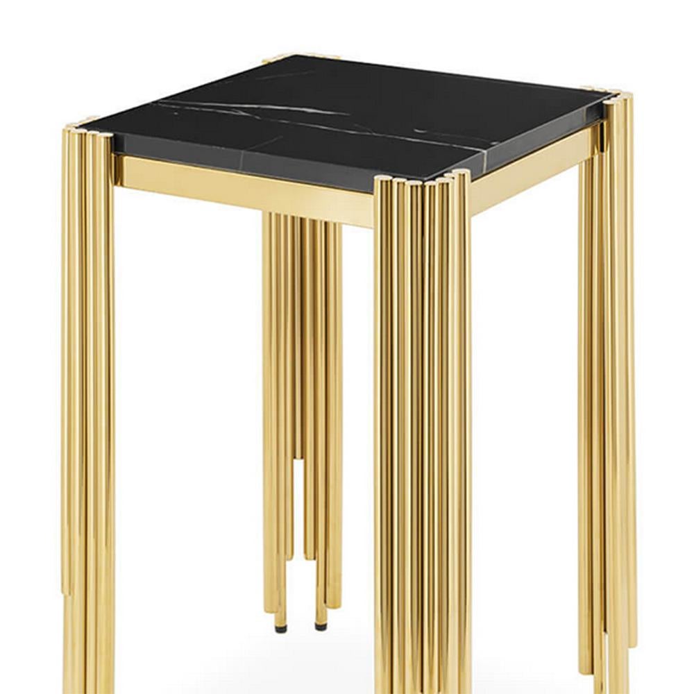 Side table Tubes II Medium with structure in 
steel in gold finish and with black marble top.