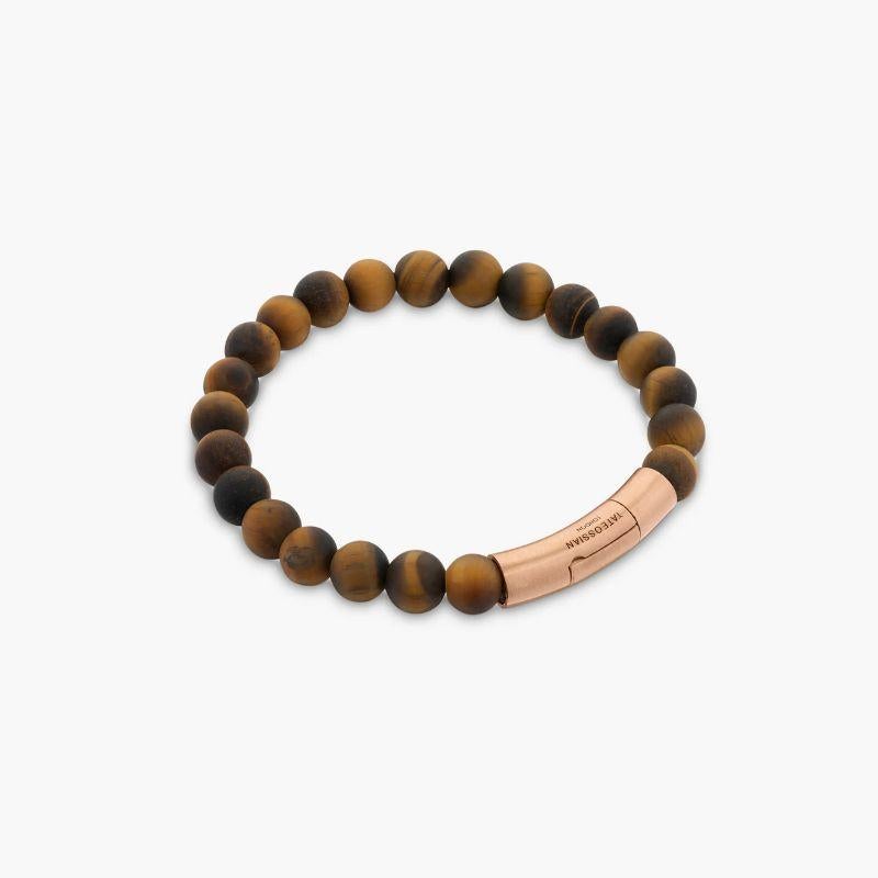Tubo Semi-Precious Bracelet in Tiger Eye and 18K Rose Gold, Size S

Large tiger eye beads with a smooth, matte finish are set onto a sterling silver chain, finished with a beautifully crafted 18k rose gold clasp, all meticulously engineered in our
