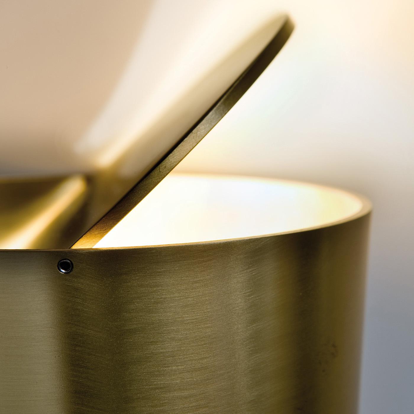 The innovative Tubo table lamp features an elegant satin brass structure with an ingenious adjustable upper disc for calibrating the light's intensity and direction. This sleek, smart lamp is the perfect piece for those discreetly elegant home or