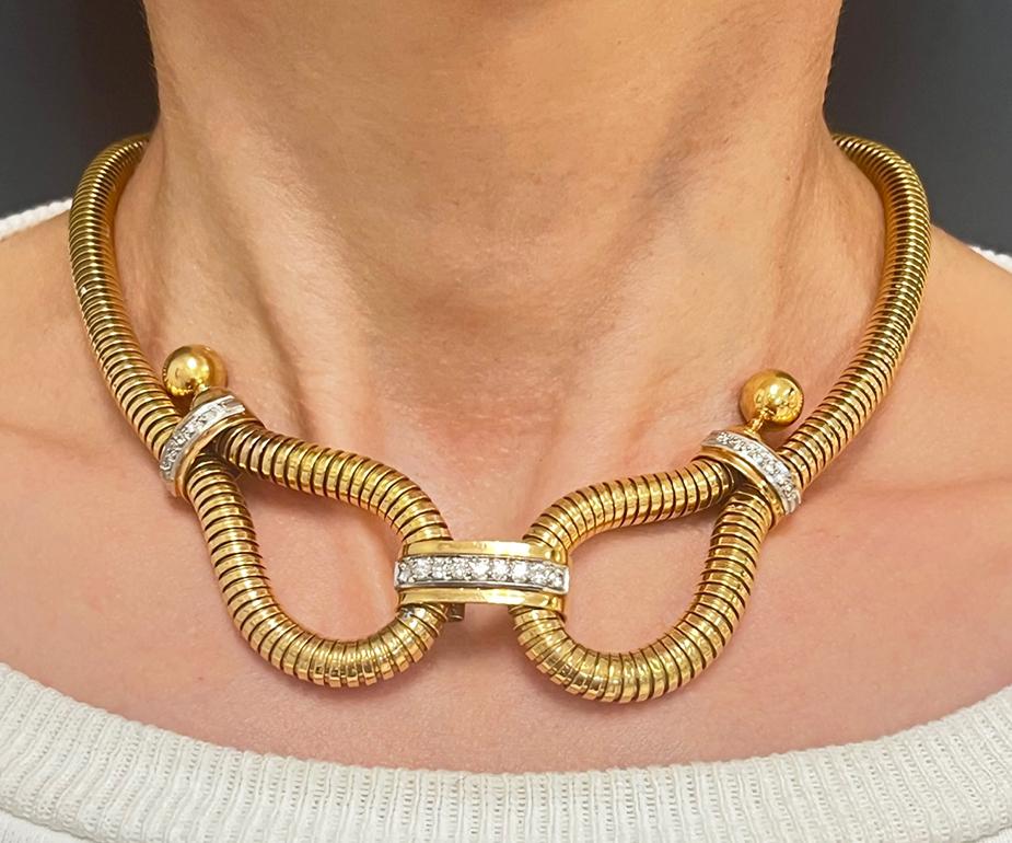 An elegant tubogas 18k gold necklace, featuring Old European cut diamonds.
It’s a gorgeous tubogas necklace from the 1940s with the distinctive features of Retro jewelry. 
The piece is designed as a linear tubogas cord with two loops on each end.