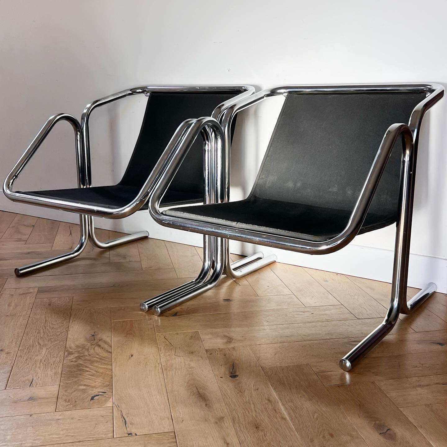 A pair of tubular chrome and canvas lounge chairs by Jerry Johnson, mid 1970s. Charcoal- hued canvas is slung over sleek and sexy tubular chrome frames. Minor signs of age but overall great condition. Pick up in Los Angeles or worldwide shipping