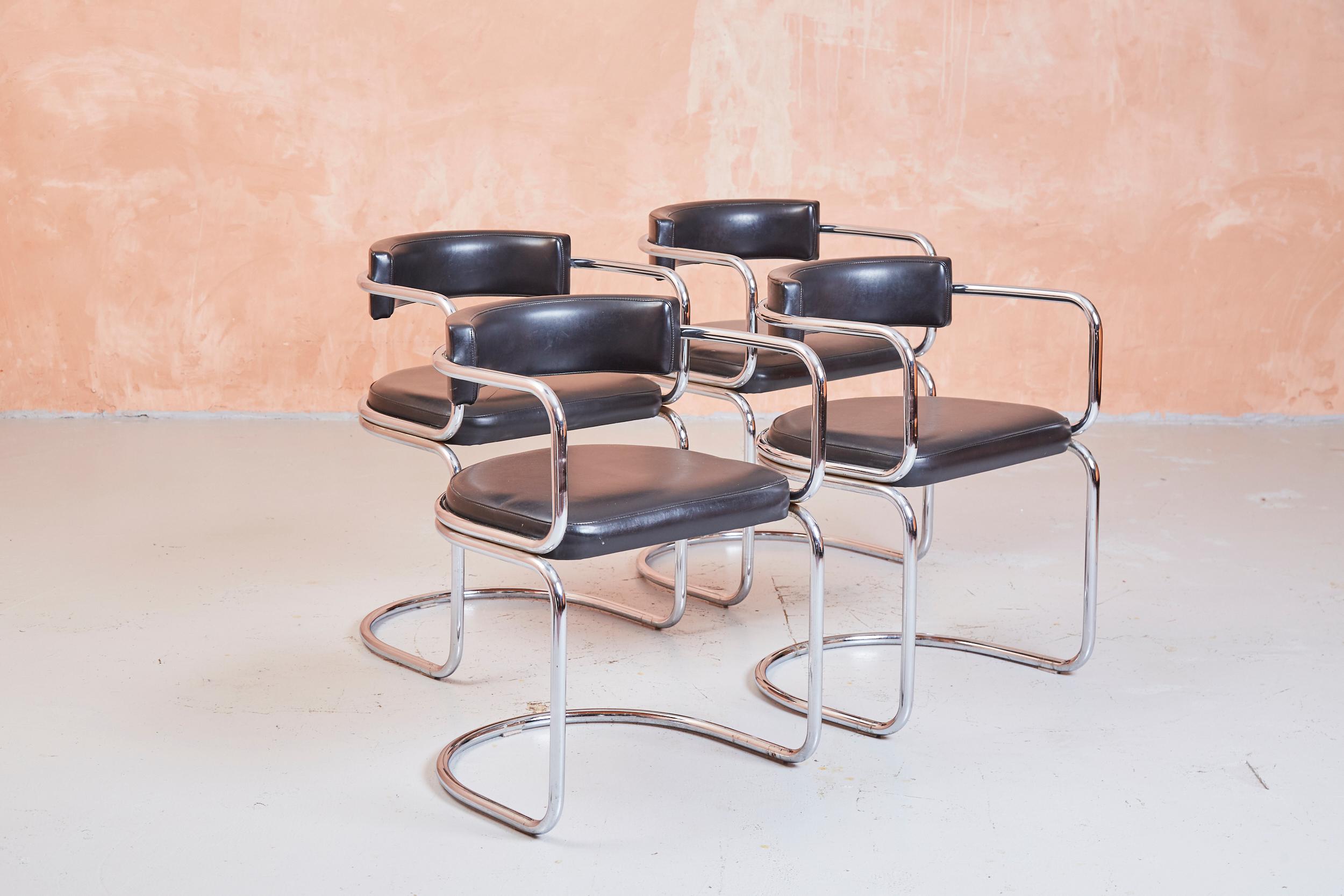 A set of four tubular framed cantilever chairs upholstered in black leatherette.

While missing any attribution marks they appear to be very fine examples of the iconic Swiss modernist chairs by Zougoise Victoria.