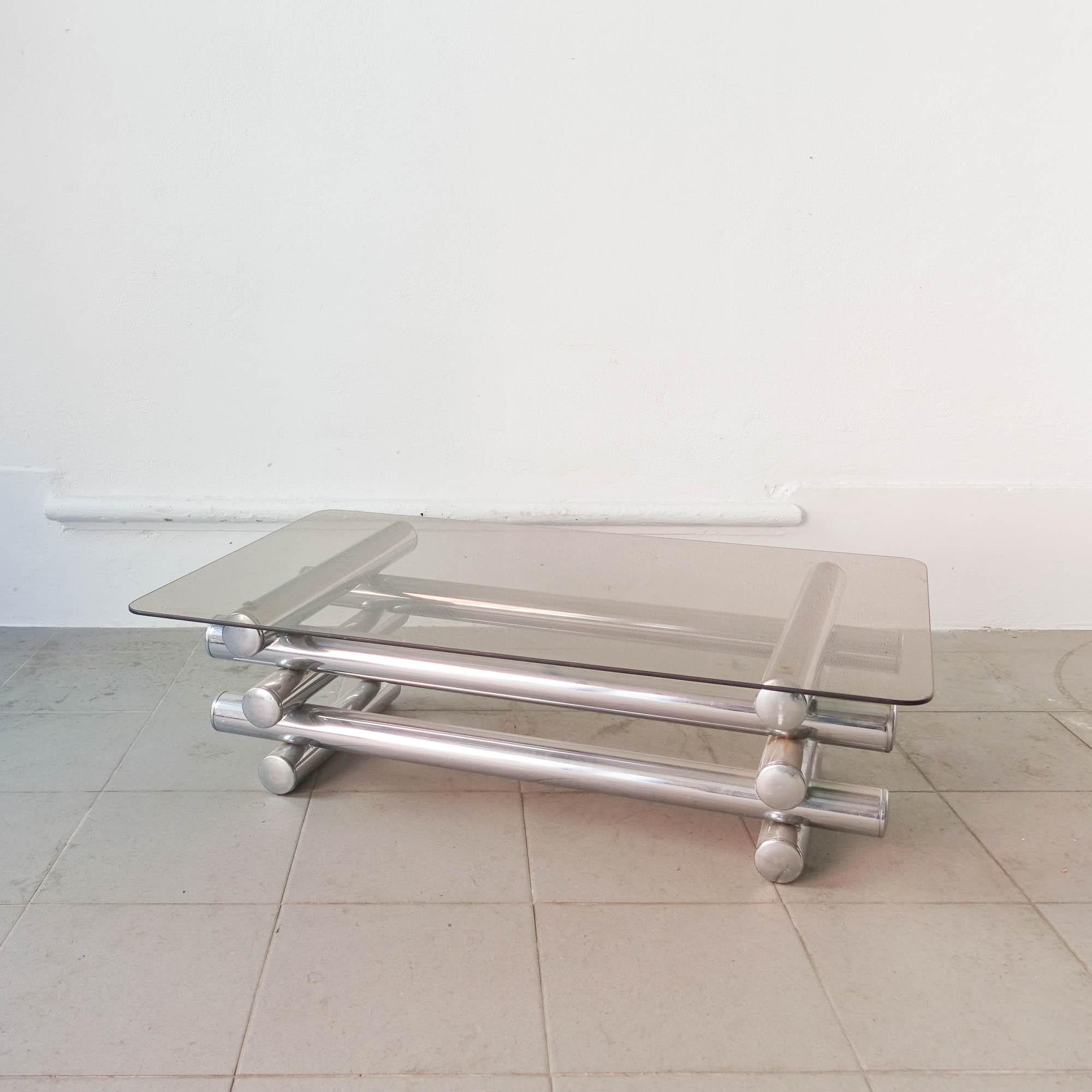 This coffee table was designed and produced in Italy during 1970's. The structure is made of chromed steel tubes on top of each other, with the top in smoked glass. It is in a good and original condition.