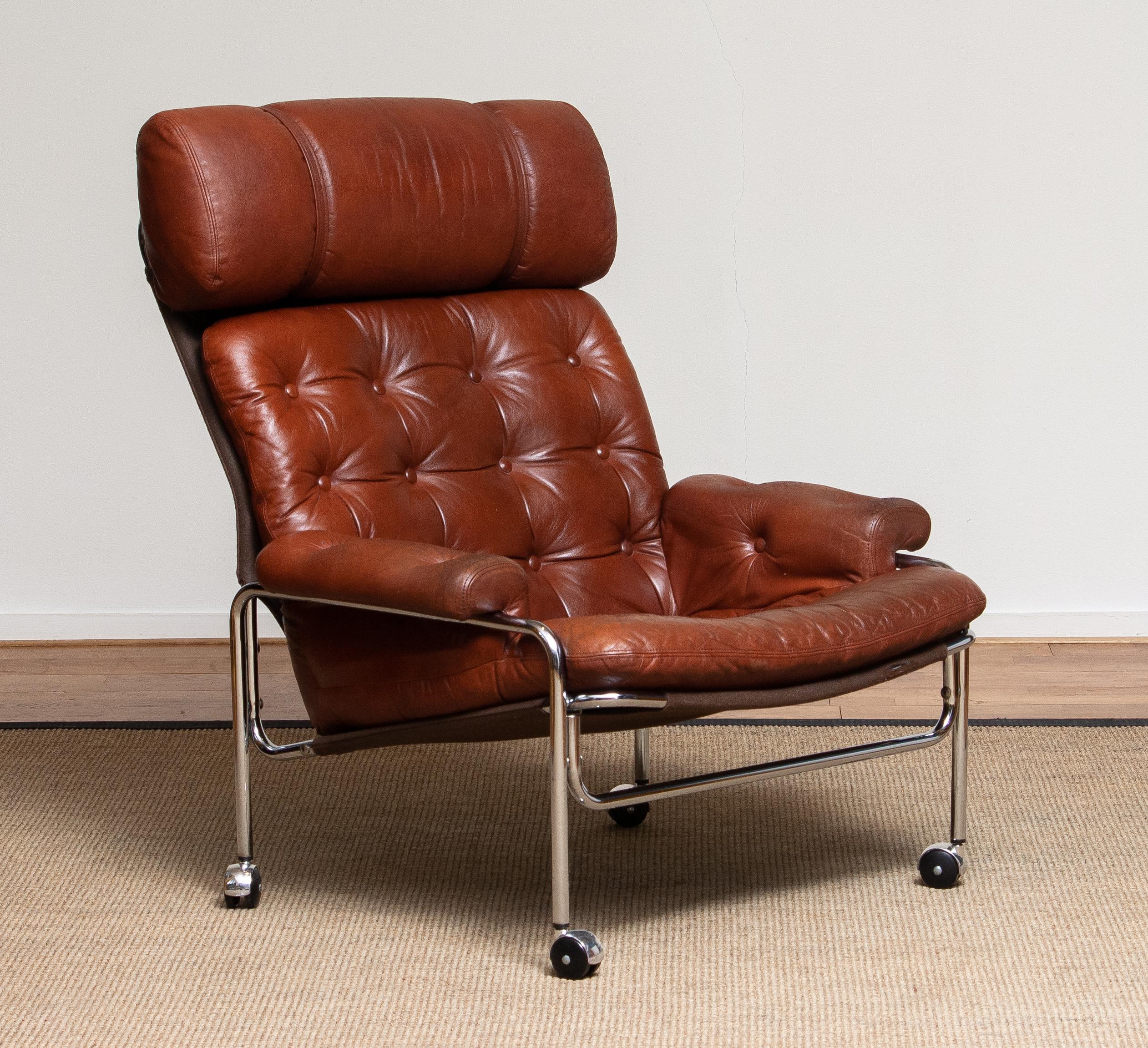 Beautiful lounge / easy chair in aged brown / cognac leather and chrome tubular frame designed by Pethrus Lindlöfs for A.B. Lindlöfs Möbler Lammhult, Sweden.
The aged leather on the chairs gives the chairs the typical vintage character. The leather