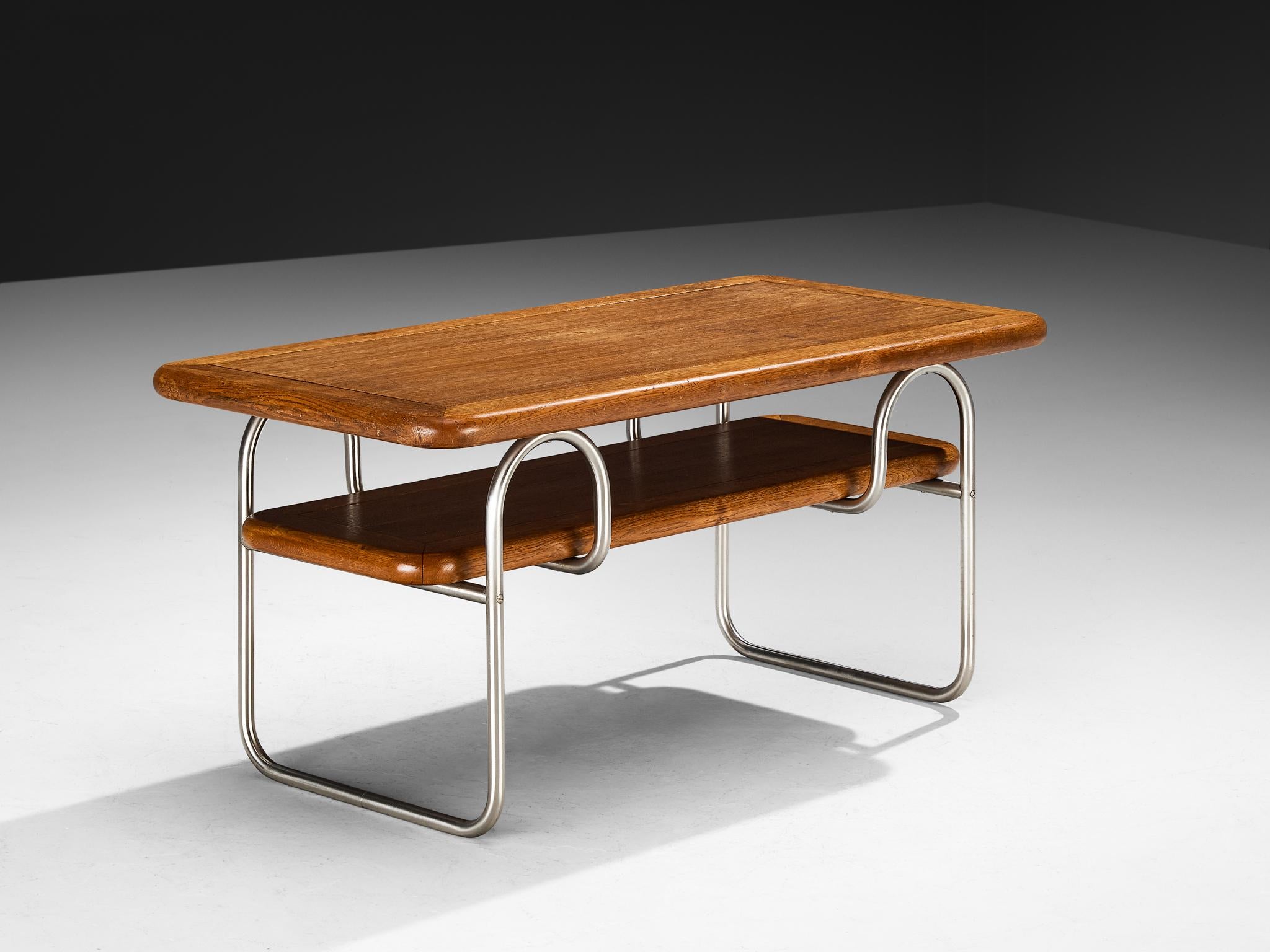 Coffee table, oak, chromed metal, Europe, 1930s

This coffee table reflects the influence of early Modernism. The design combines a tubular chromed metal frame with two rectangular oak tops, the upper surface framed by softly rounded edges. The
