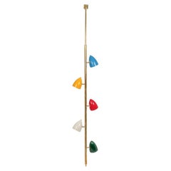 Tubular hanging lamp in patinated and lacquered brass. Contemporary