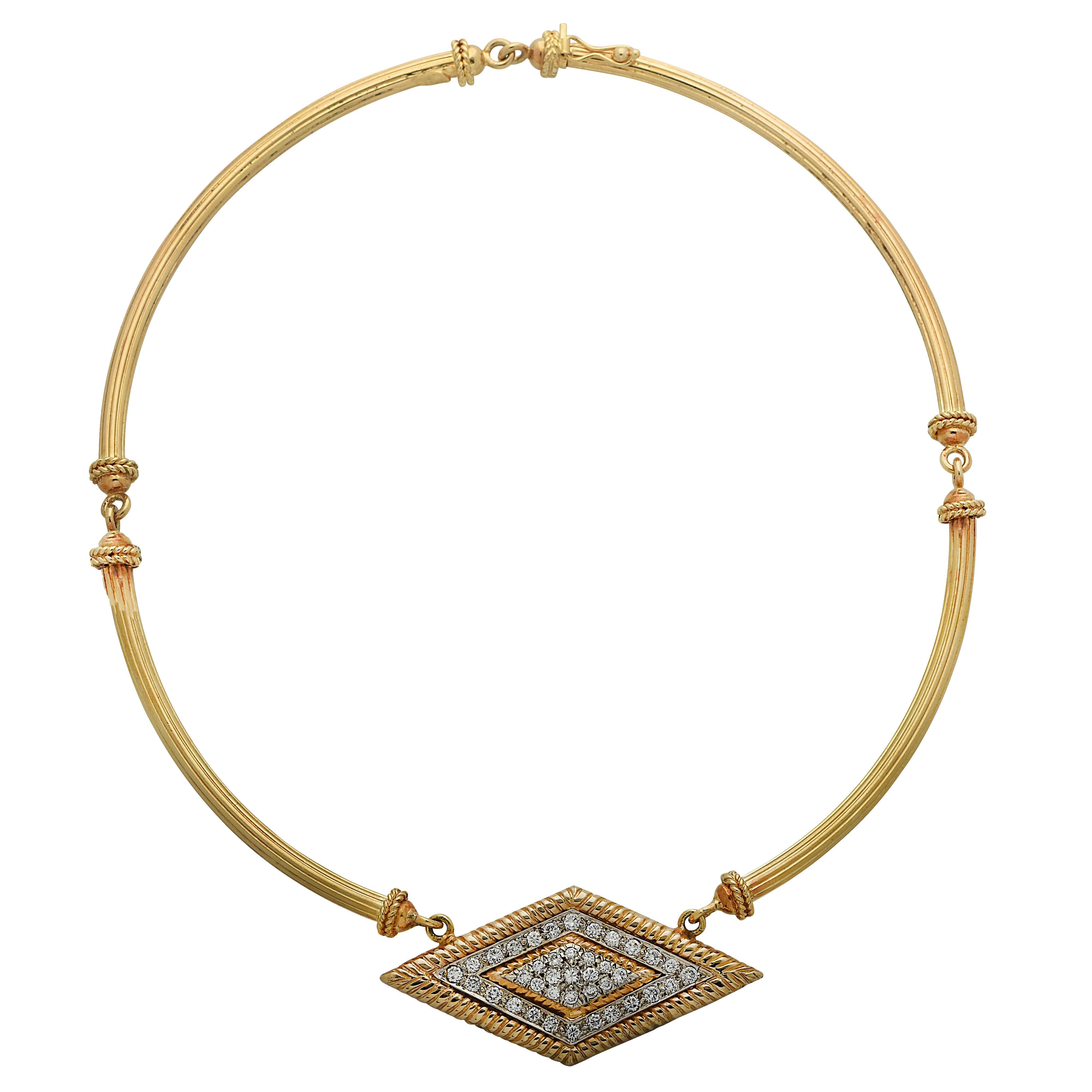 Tubular hinged collar necklace crafted in 18 karat yellow gold detailed with baubles, culminating in a diamond shaped plate crafted in 18 karat yellow and white gold, encrusted with 39 round brilliant cut diamonds weighing approximately 2 carats