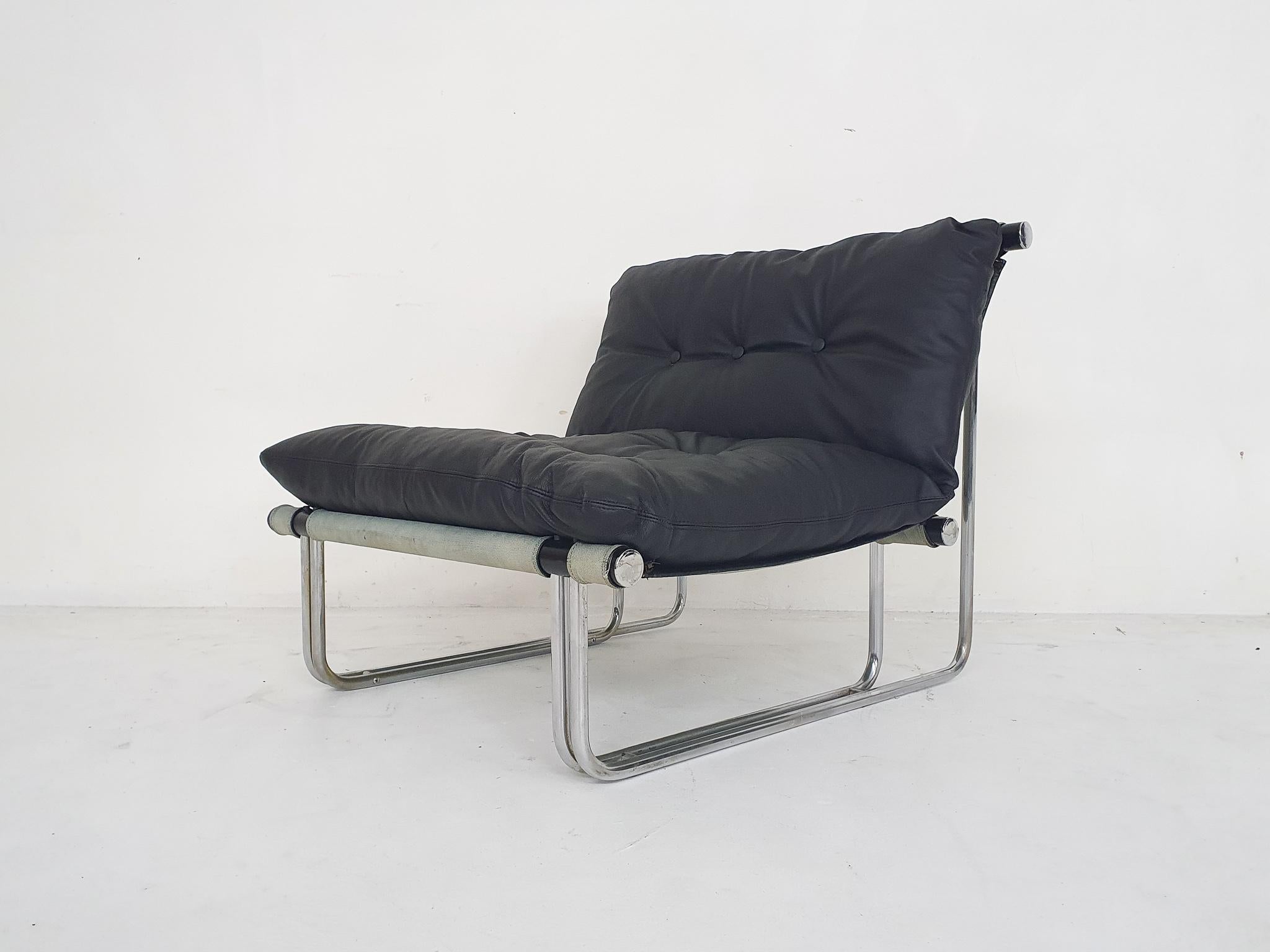 Tubular lounge chair with canvas seating and black leather cushion by Steiner.
The cushion has been re-upholstered, and are attached to the canvas with zippers.
Unfortunately we can not find this model, but the designer might be Pascel Mourgue or