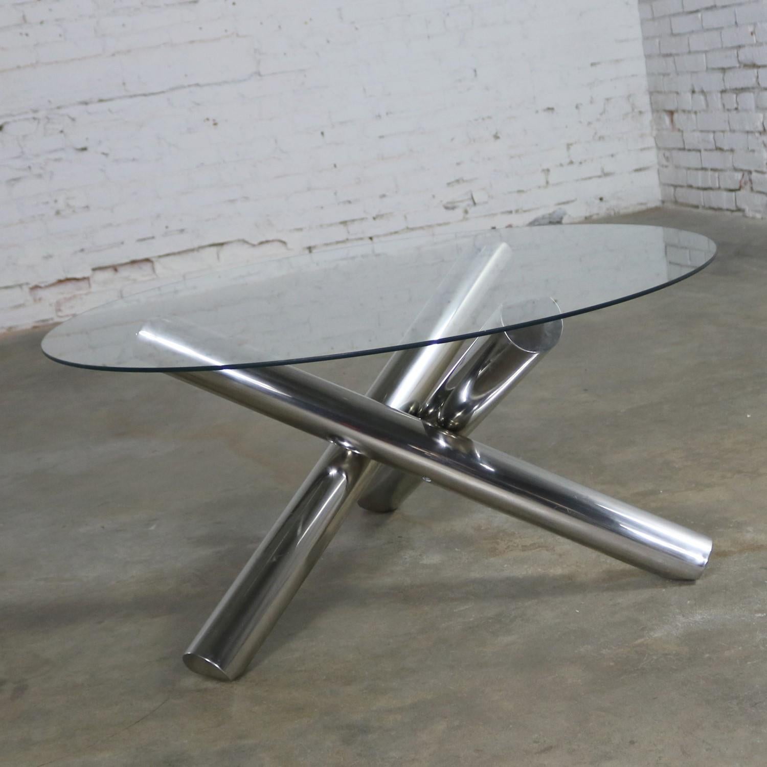 Incredible stainless steel jacks shaped or tripod coffee table with a round glass top. It is in wonderful vintage condition. It does have a visible scrape on one of the legs, but you must look for it and it does not detract from its beauty. Please