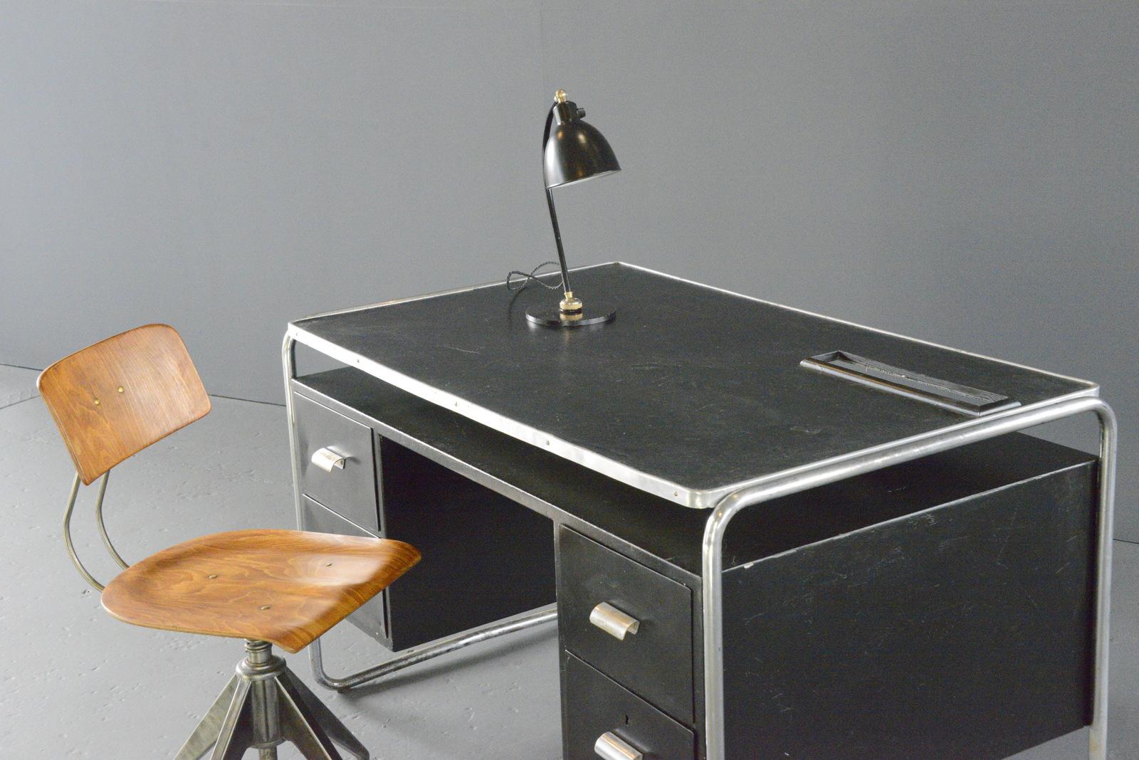 Tubular Steel Bauhaus Desk By Mauser Circa 1930s

- Chromed tubular steel frame
- Nickel plated brass handles
- 4 drawers
- Black linoleum top
- Storage in the front of the desk for files, books etc
- Made by Mauser Werke
- Salvaged from the