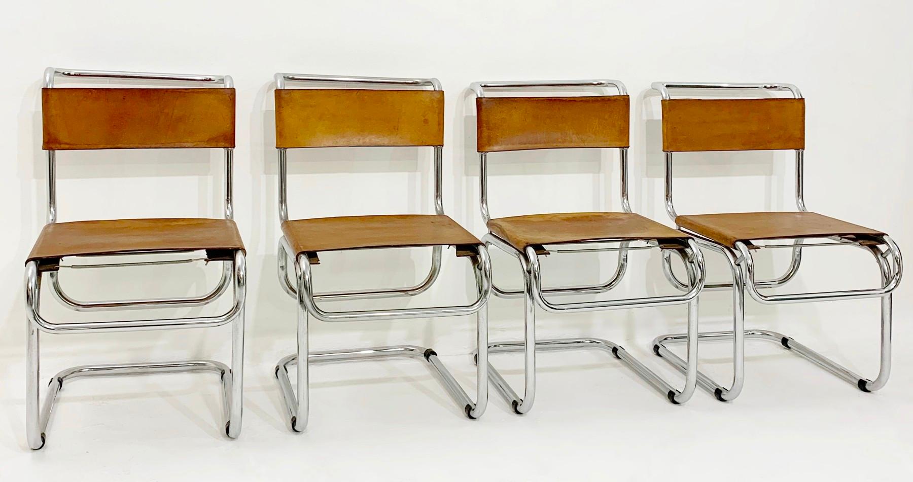 Tubular steel and cognac leather cantilever chairs.