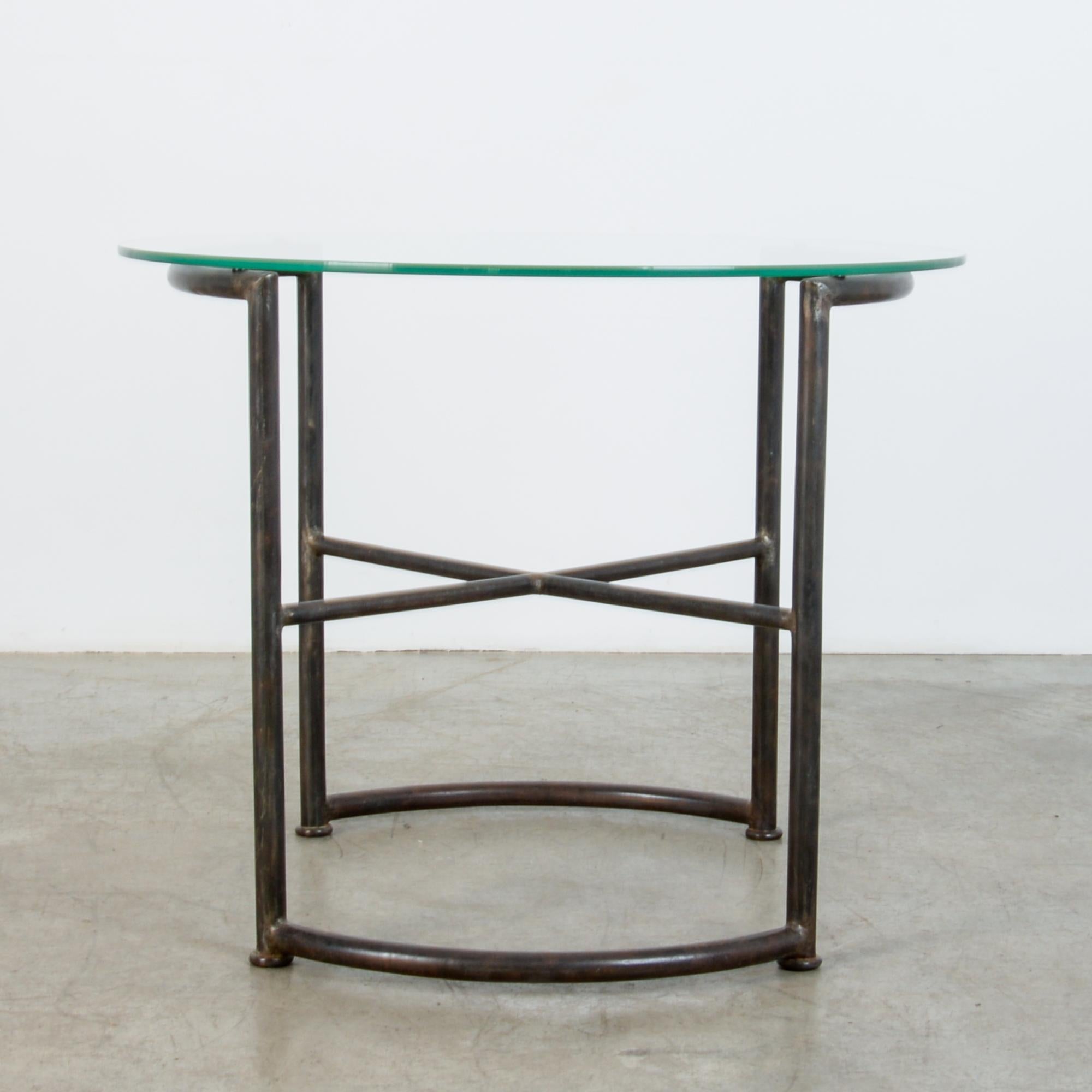 Made in Germany circa 1920, this metal table is realized in typical Bauhaus fashion, with blended geometries, complex yet intelligible. Developing the ubiquitous materials of industry, the now familiar construction from tubular steel was a