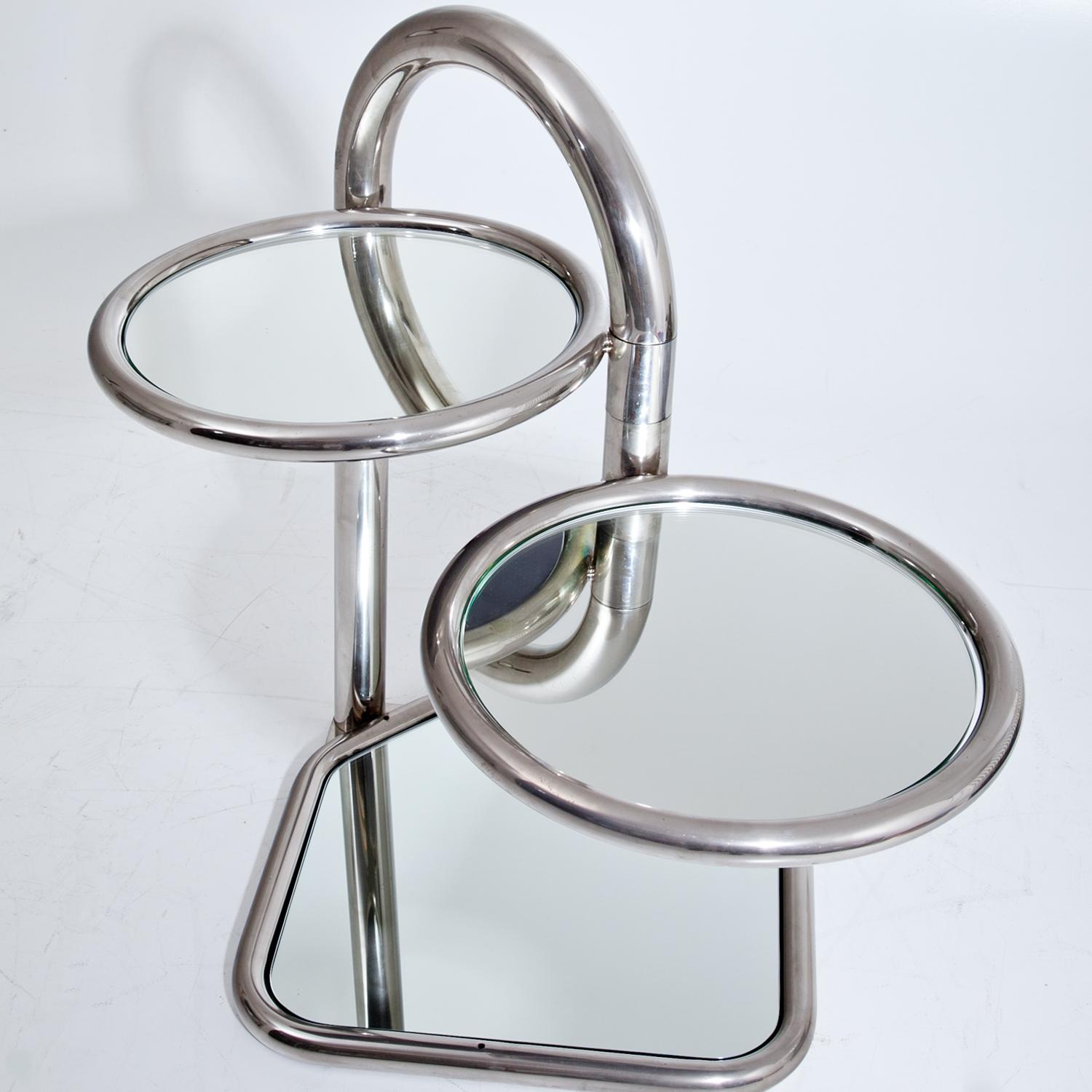 Tubular steel pipe side table of the 1940s, standing on a square base with two adjustable round tiers. These all have mirror panes as tabletops.