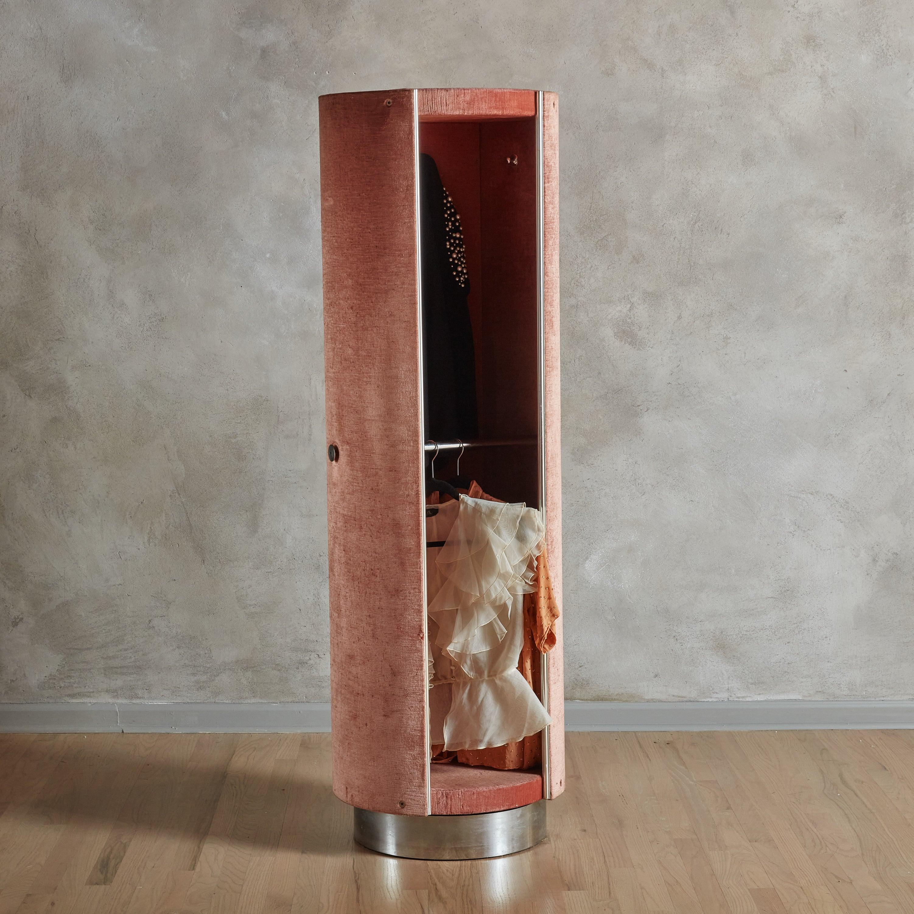 The 'Tucroma' rotating wardrobe was designed by Guido Faleschini for i4Mariani in the 1970s. This rare armoire captivates with its original pink velvet exterior, accented with sleek chrome hardware. It is mounted on a chrome plinth base, and a