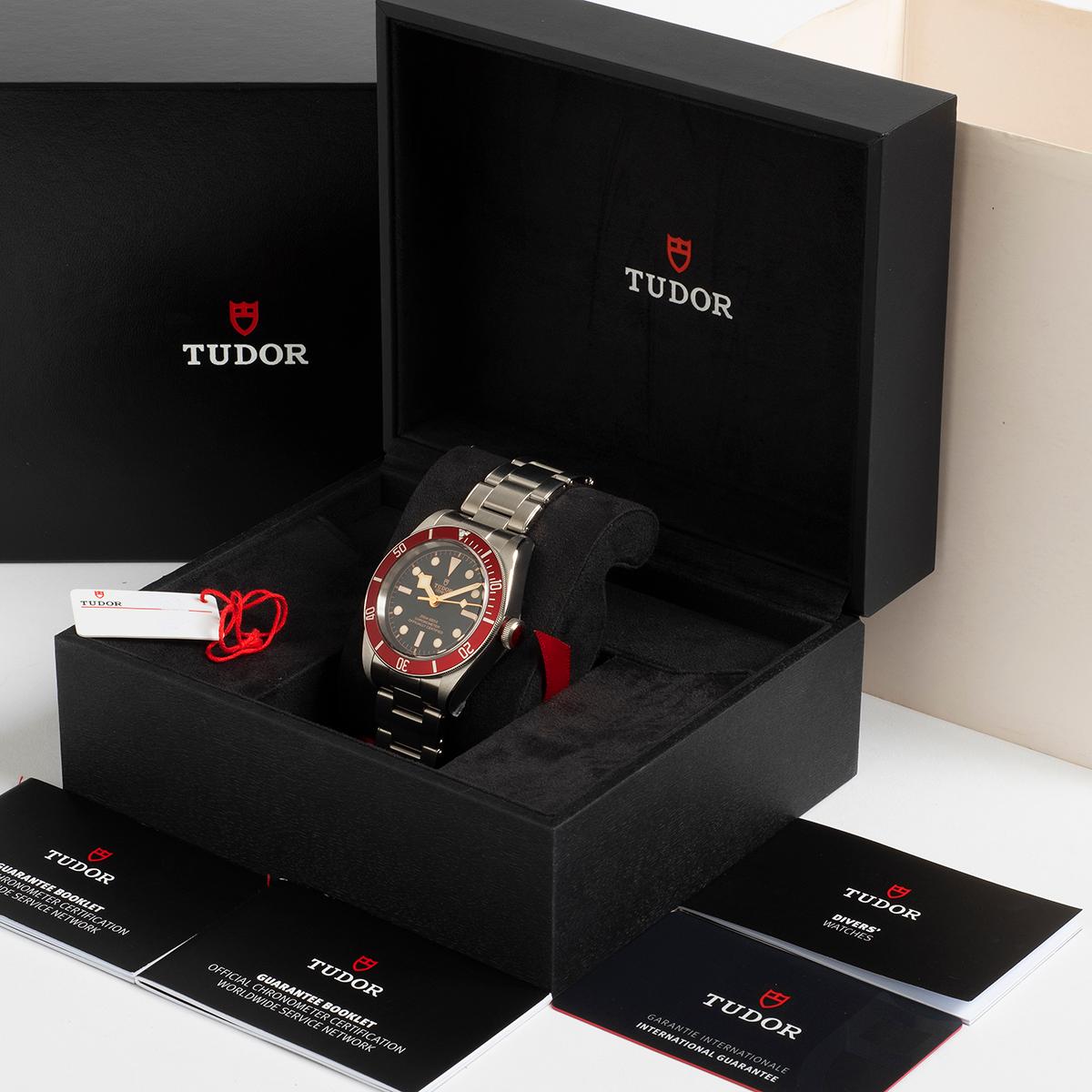 Our Tudor Black Bay Red reference M79230R is presented in unworn condition with stickers attached to the case and bracelet as well as clasp. A desirable variant of the Tudor black bay range, with the later Tudor in house movement , our Tudor comes
