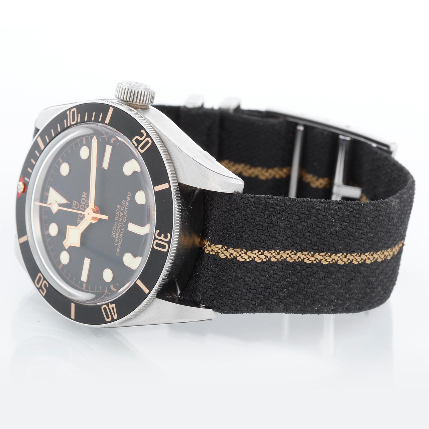 Tudor by Rolex Heritage Black Bay Men's Stainless Steel Watch 79030N - Self winding. Stainless steel case with rotating bezel; black bezel insert (41mm diameter). Black dial with luminous-style hour markers. Black strap with buckle . Unused with