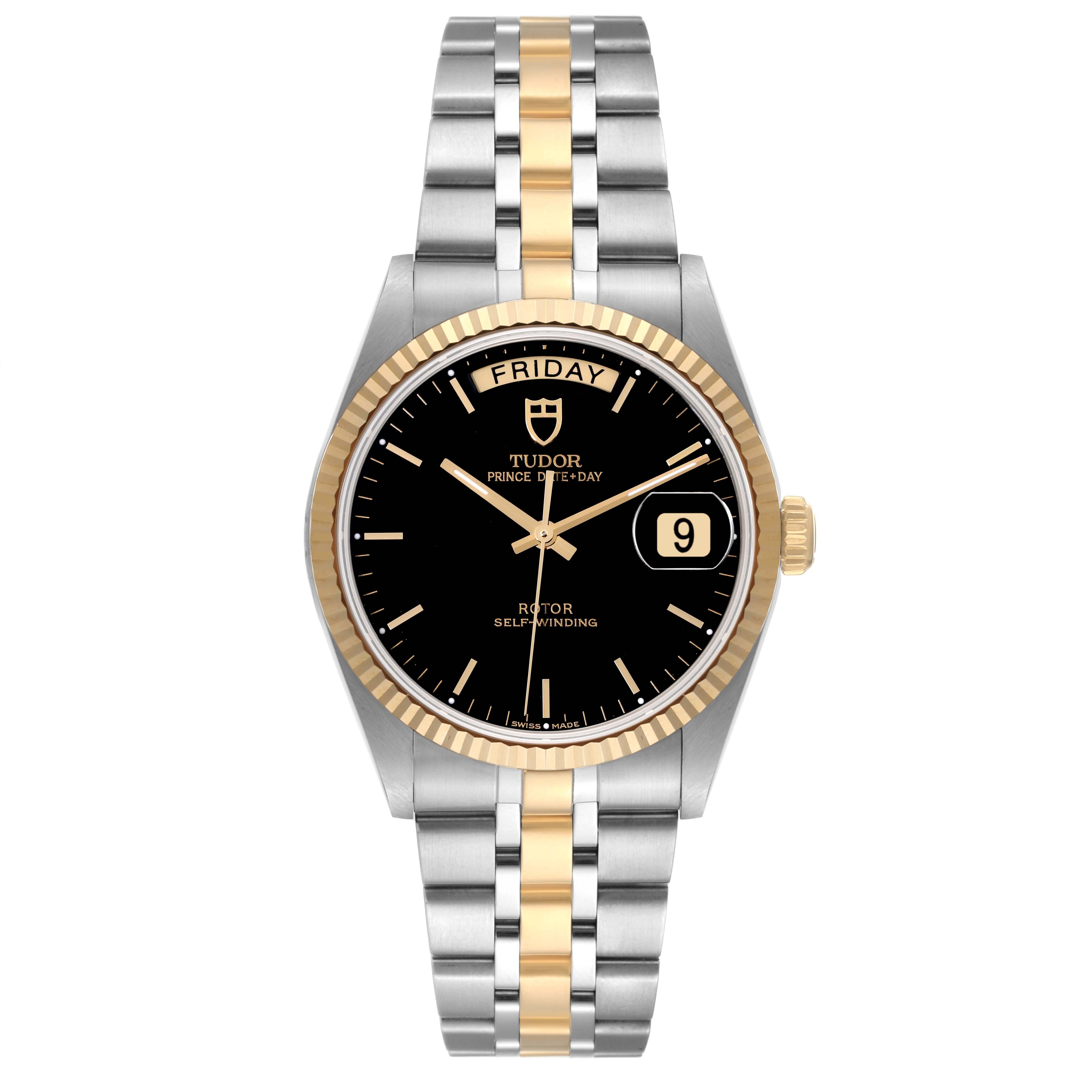 Tudor Day Date Black Dial Steel Yellow Gold Mens Watch 76213 Box Card. Automatic self-winding movement. Stainless steel round case 36.0 mm in diameter. 18k yellow gold fluted bezel. Scratch resistant sapphire crystal with cyclops magnifier. Black