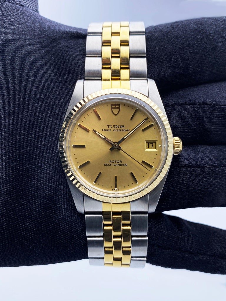 Tudor Prince OysterDate 74033 Mens Watch. 34mm stainless steel case with 18K yellow gold fluted bezel. Champagne dial with gold hands and index hour marker. Date display at the 3 o'clock position. Stainless steel & 18K yellow gold Jubilee bracelet
