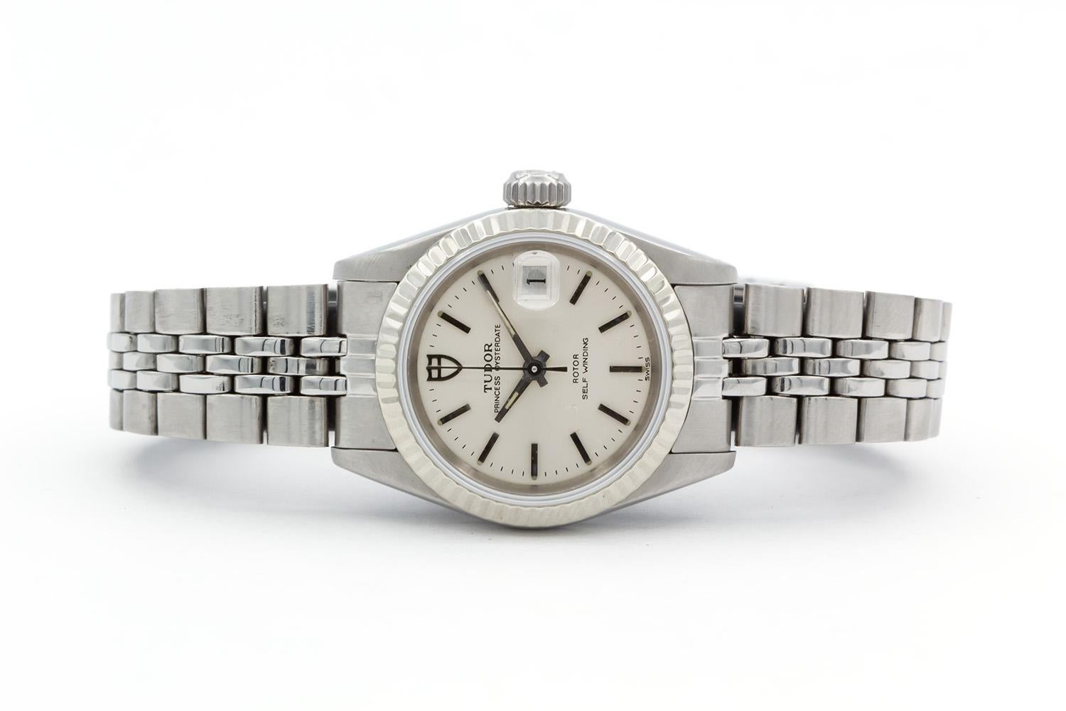 We are pleased to offer this Tudor Princess Oyster Date 92414N. It is all original and features a 25mm stainless steel case 18k white gold fluted bezel, silver stick dial with date aperture, stainless steel jubilee bracelet. It will fit up to a 6.5