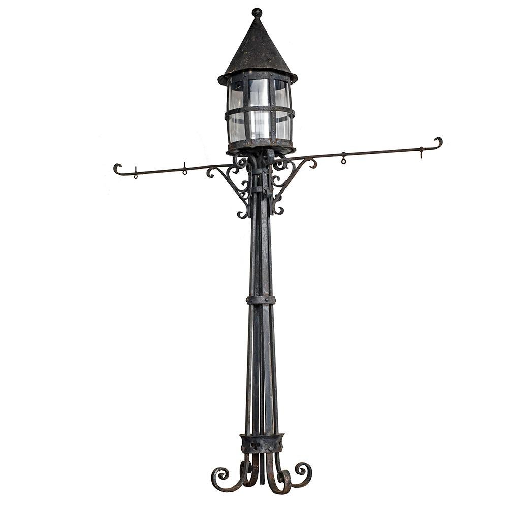 These wrought iron street lights have a distinct Tudor Revival aesthetic. They were salvaged from the no longer extant Lloyd Golf Club in Portland, which was built in the late 1920s. One streetlight has lateral arms, most likely for address plates