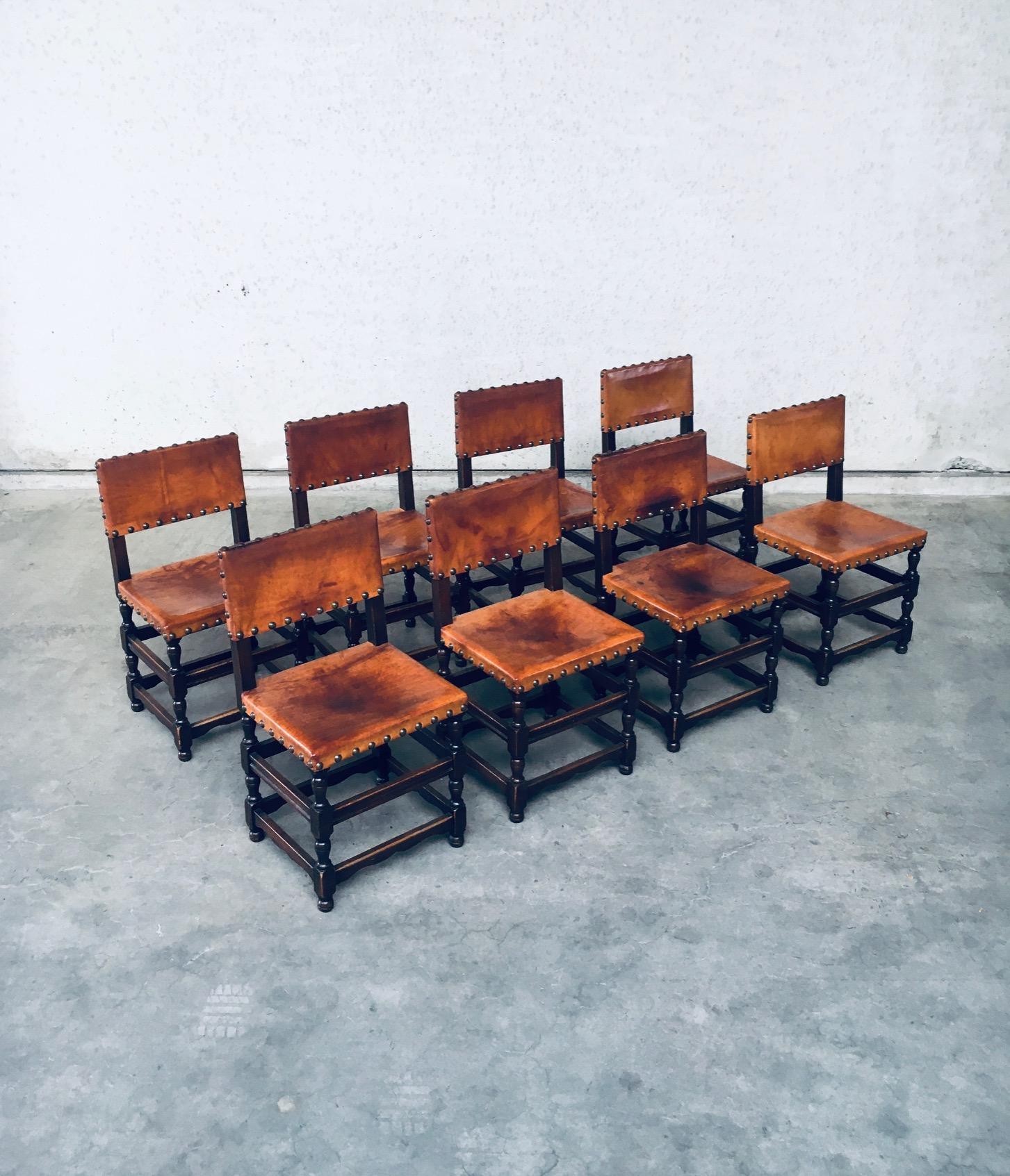 Vintage Tudor Style Cromwelian Design Style Leather Dining Chair set of 8. Made in England, 1940's. Oak dark stained frame with thick cognac natural leather seat and back, finished with brass studs. All chairs are nicely patinated on the leather