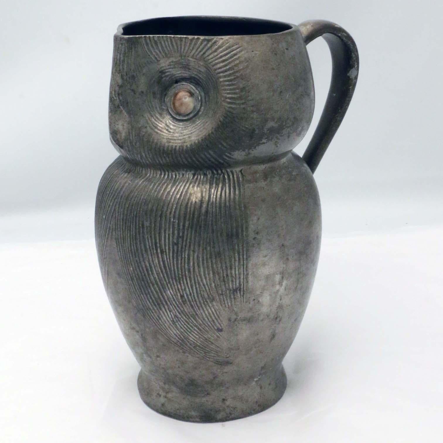 This example, made for Liberty circa 1905, has inlaid shell eyes. There are other similar notable examples in pottery also retailed by Liberty. this is an especially charming example.