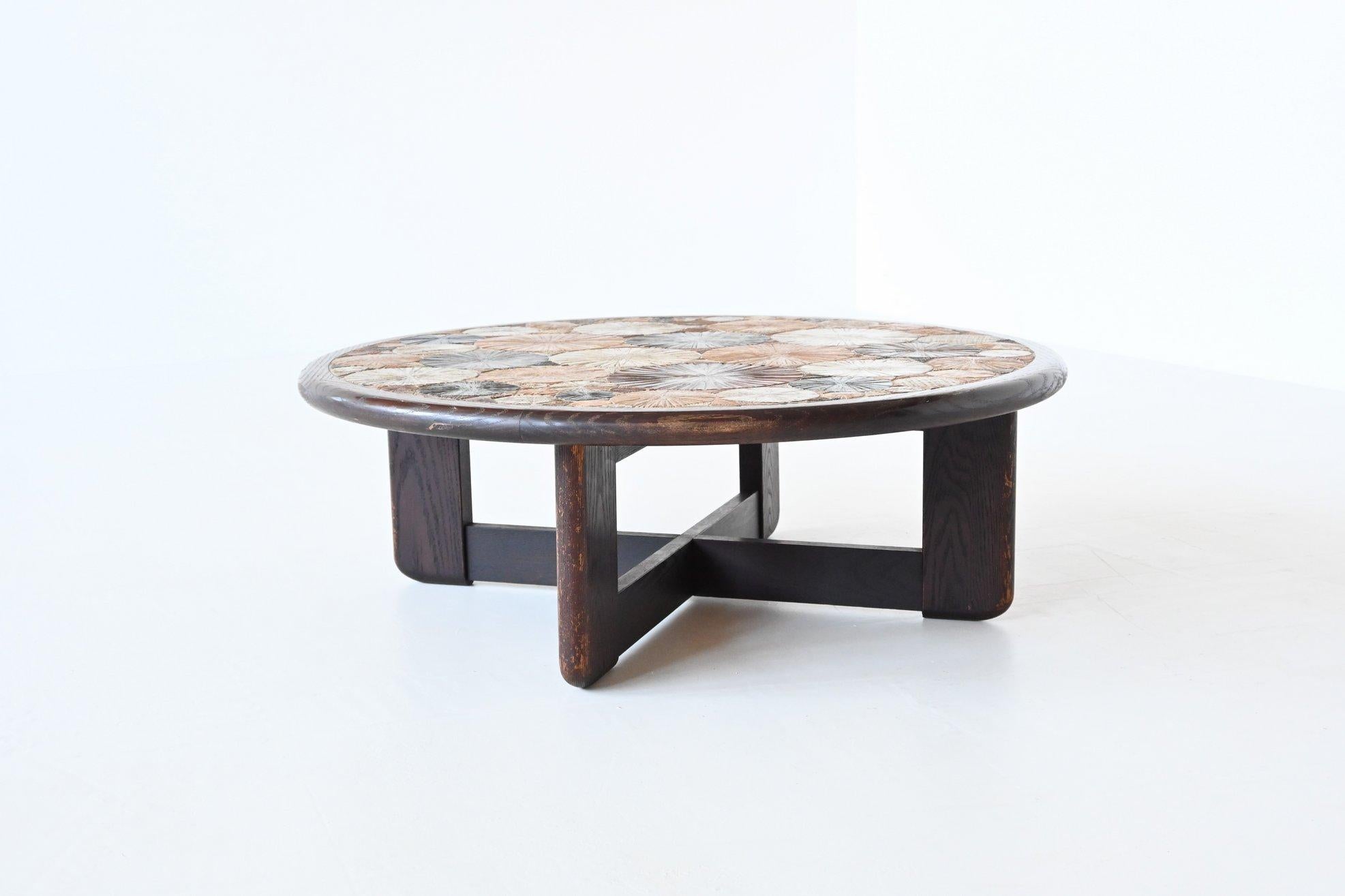 Beautiful artwork coffee table designed by Tue Poulsen for Haslev Møbelsnedkeri A/S, Denmark 1963. This well-crafted coffee table has a dark brown stained oak wooden frame and rim, inset with incised, hand painted bright glazed ceramic tiles in