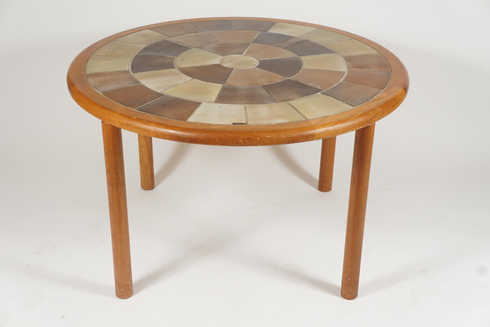 A great sized sturdy teak with ceramic tile top dowel legged dining/dinette in teak. The table is designed by Tue Poulsen and labeled Haslev. Made in Denmark.