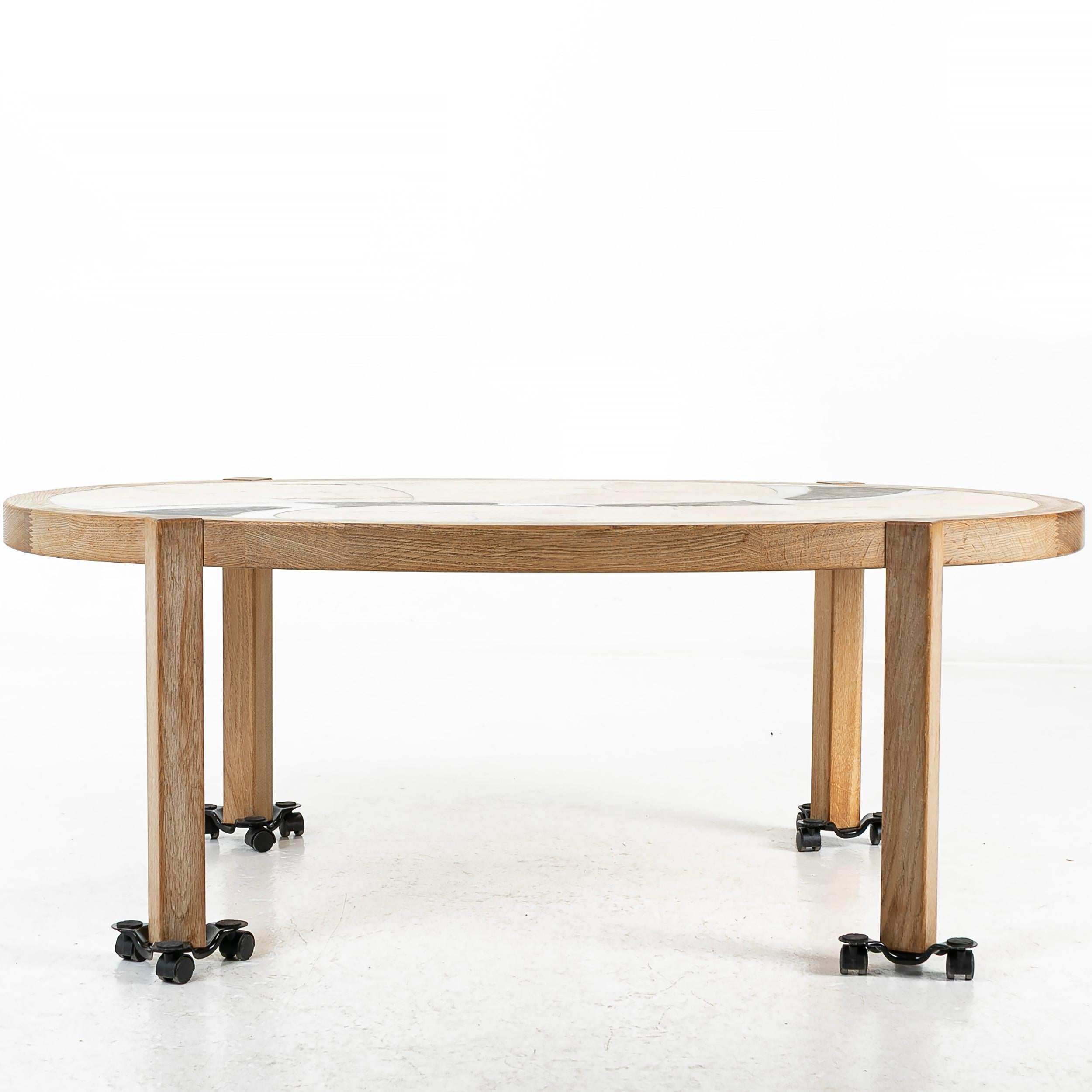 Danish modern side or end table by Tue Poulsen for Haslev Møbelsnedkeri A/S, Denmark. round form top with Solid teak legs. The top is inset with incised ceramic and stone circled with solid Teak wood.

Good condition 