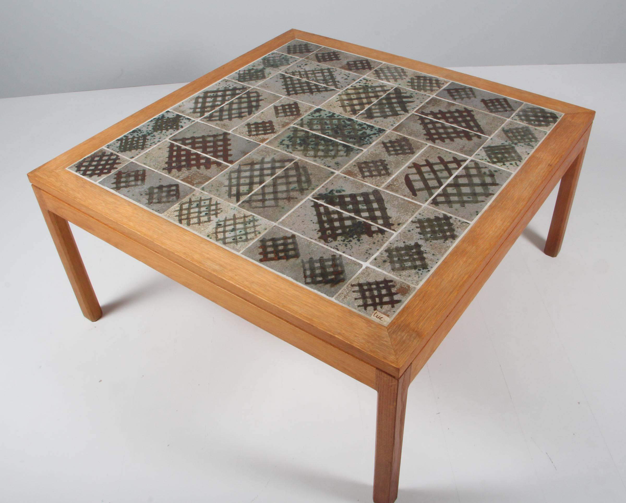 Tue Poulsen coffee table with frame of solid oak. Stoneware tiles made by the artist Tue Poulsen.

Made in Denmark in the 1970s.

 
