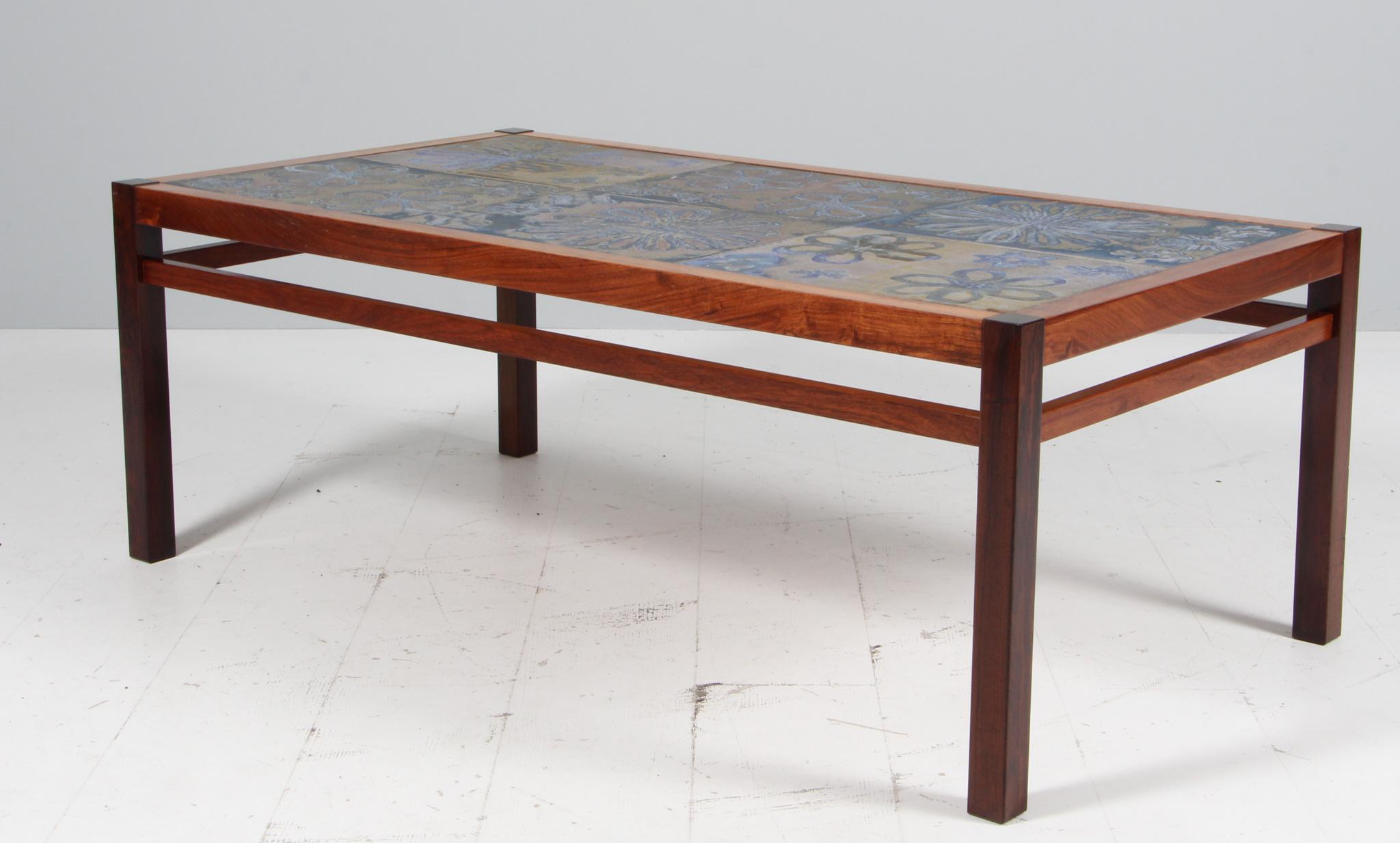 Tue Poulsen coffee table with frame of solid rosewood. Stoneware tiles made by the artist Tue Poulsen.

Made in Denmark in the 1970s.

 