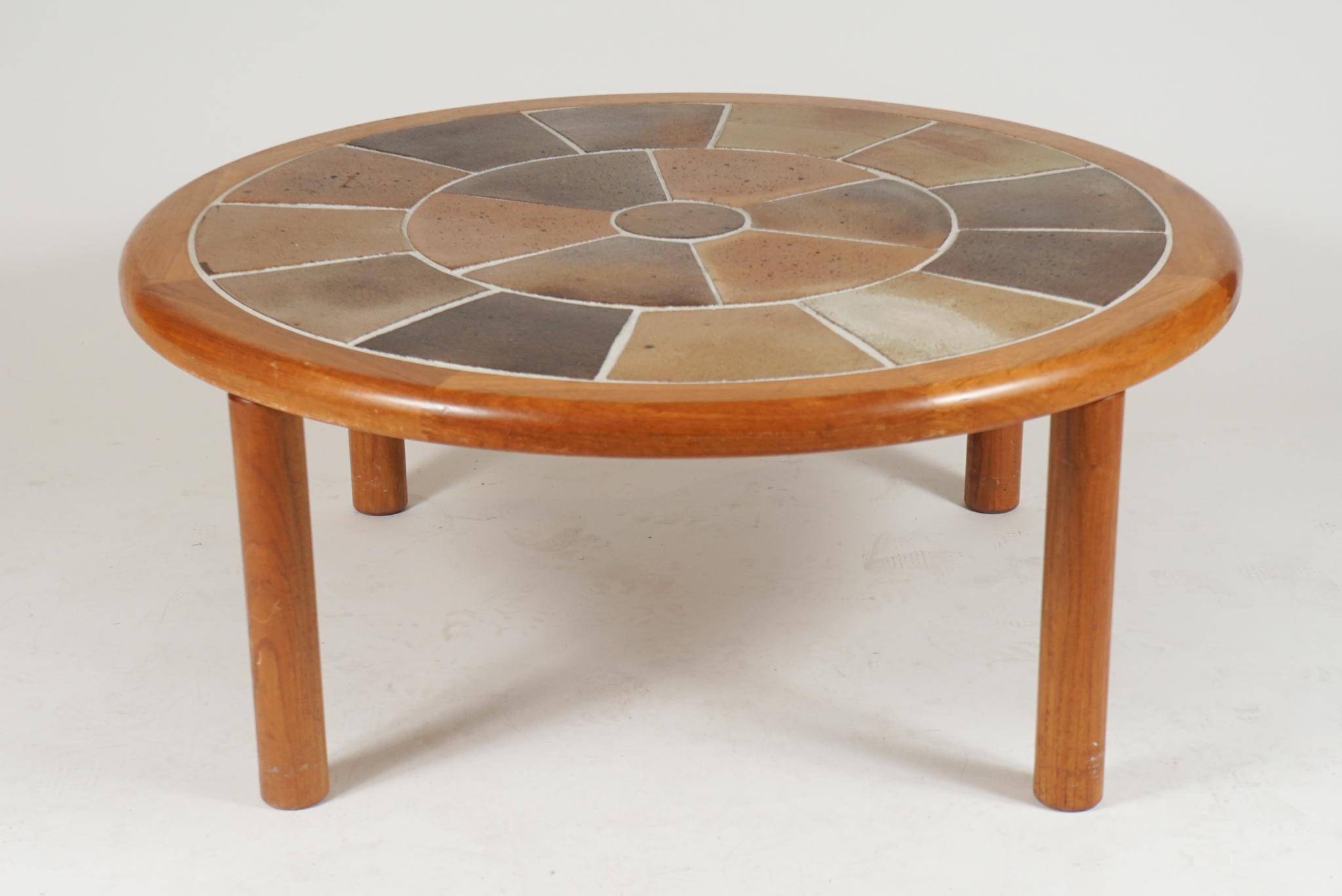 A great sized sturdy Danish teak coffee table with ceramic tile top. Very usable and stunning solid Danish coffee table. The table is designed by Tue Poulsen and labeled Haslev. Made in Denmark. Perfect for any 'Hygge' environment!