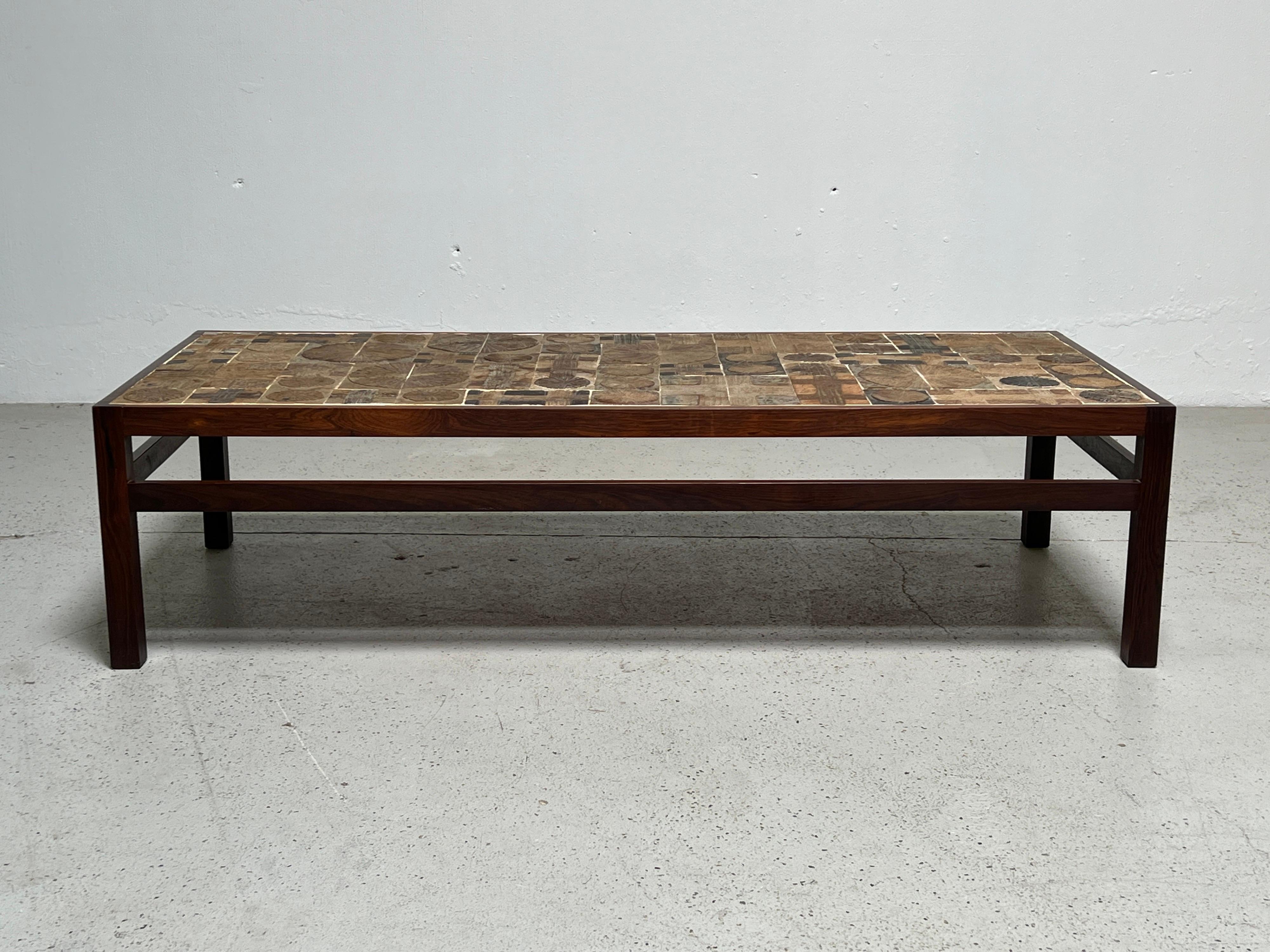 A large rosewood and ceramic tile top table by Tue Poulsen & Erik Wørtz for Willy Beck.