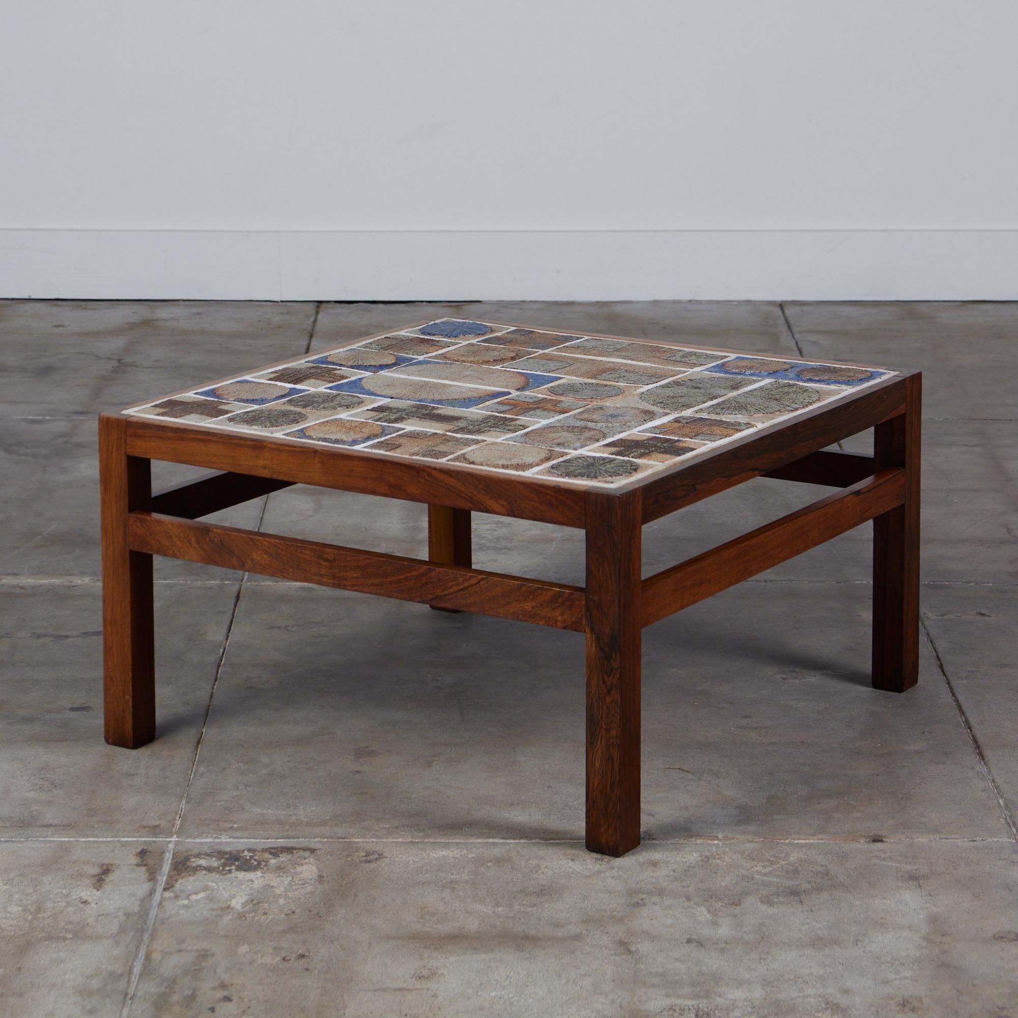 Tile topped coffee table designed by Tue Poulsen for Willy Beck, c.1960s, Denmark. The square rosewood frame and legs were designed by Erik Wörtz and the ceramic tiles were created by artist Tue Poulsen.

Cites notice: Due to stringent regulations