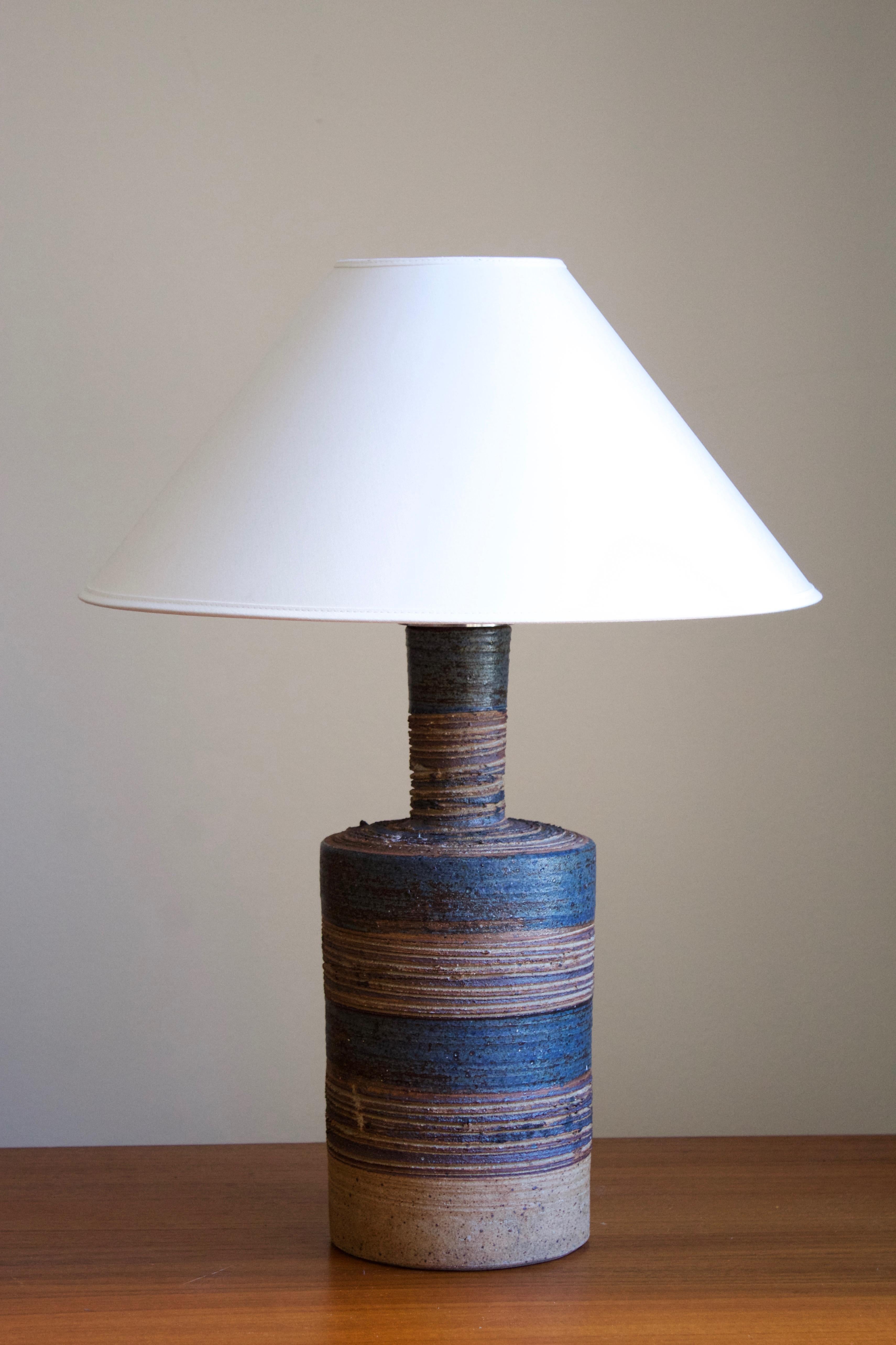 A sizable table lamp. Produced and designed by Tue Poulsen, Denmark, 1960s. Underside of base signed.

Sold without lampshade. Stated dimensions exclude lampshade. Height includes socket.

Glaze features brown-blue colors.

Other designers of the