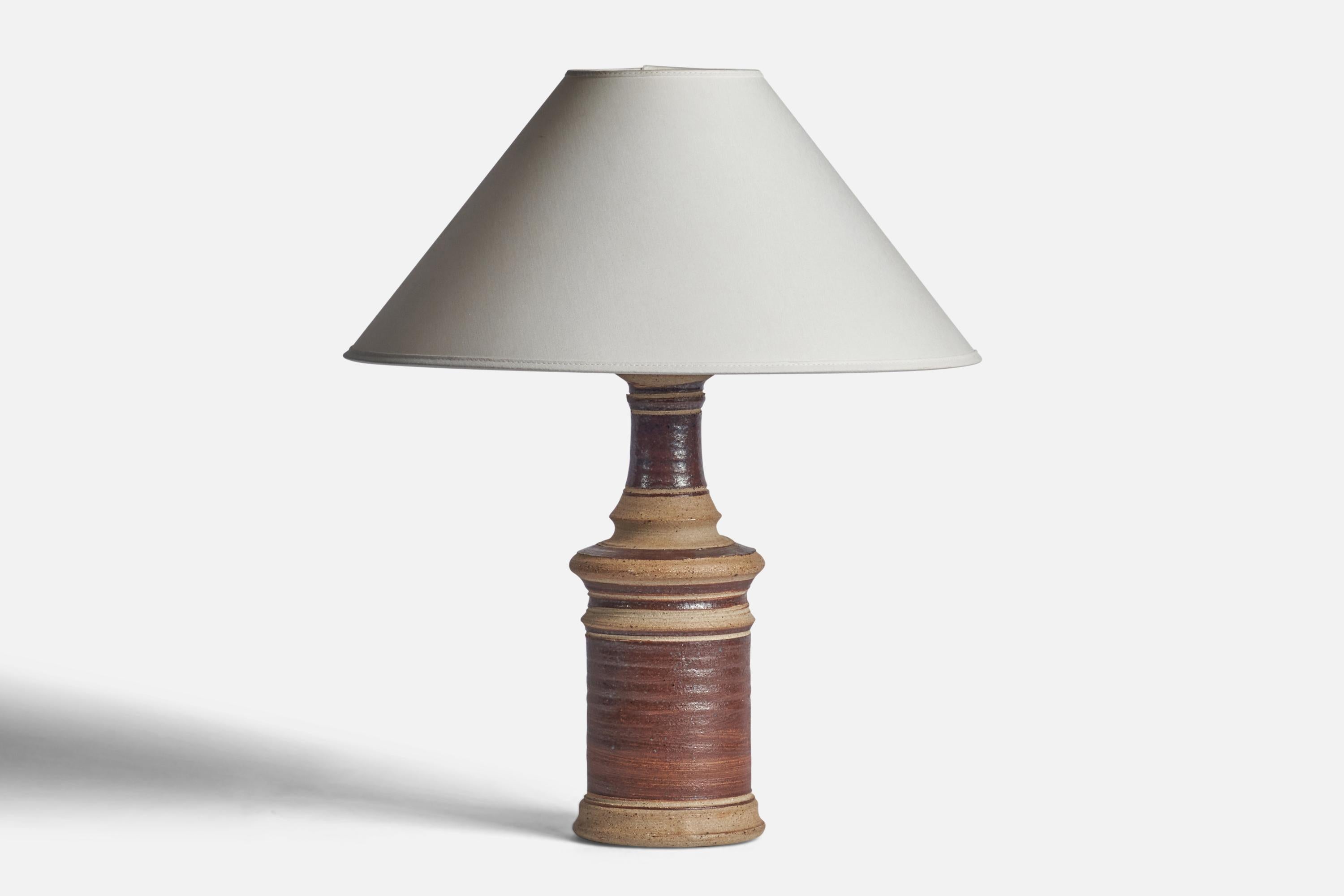 A beige and brown-glazed stoneware table lamp designed and produced in Denmark, 1960s.

Dimensions of Lamp (inches): 15” H x 5” Diameter
Dimensions of Shade (inches): 4.5” Top Diameter x 16” Bottom Diameter x 7.25” H
Dimensions of Lamp with Shade