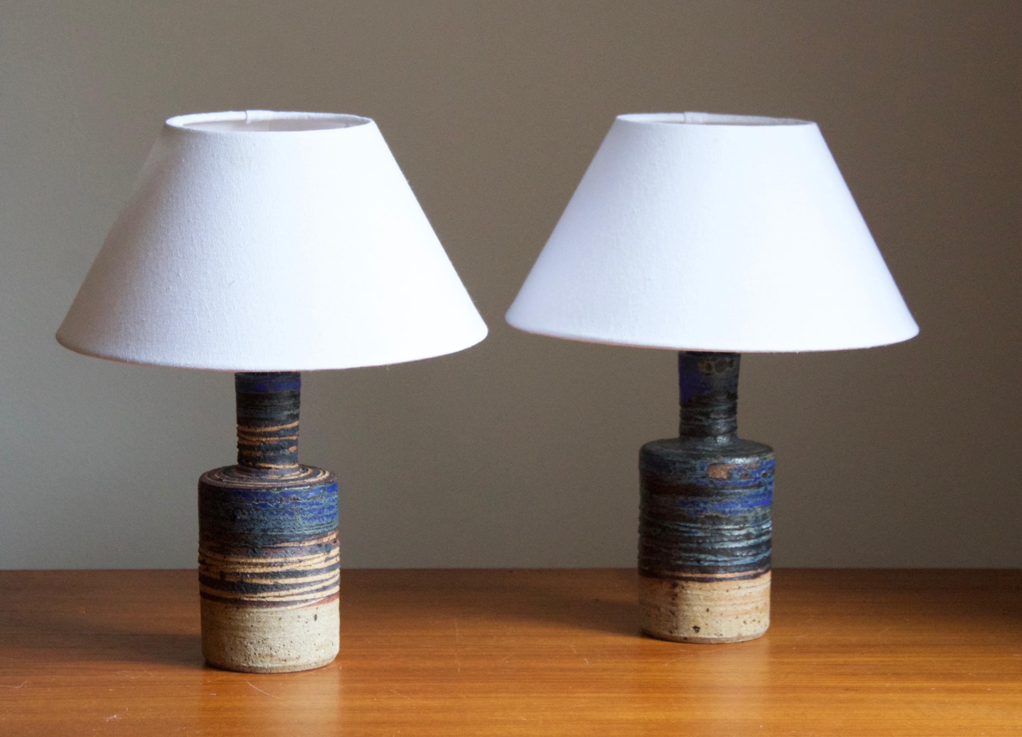 A sizable table lamp. Produced and designed by Tue Poulsen, Denmark, 1960s. Underside of base signed.

Sold without lampshade. Stated dimensions exclude lampshade. Height includes socket.

Other designers of the period include Axel Salto, Arne