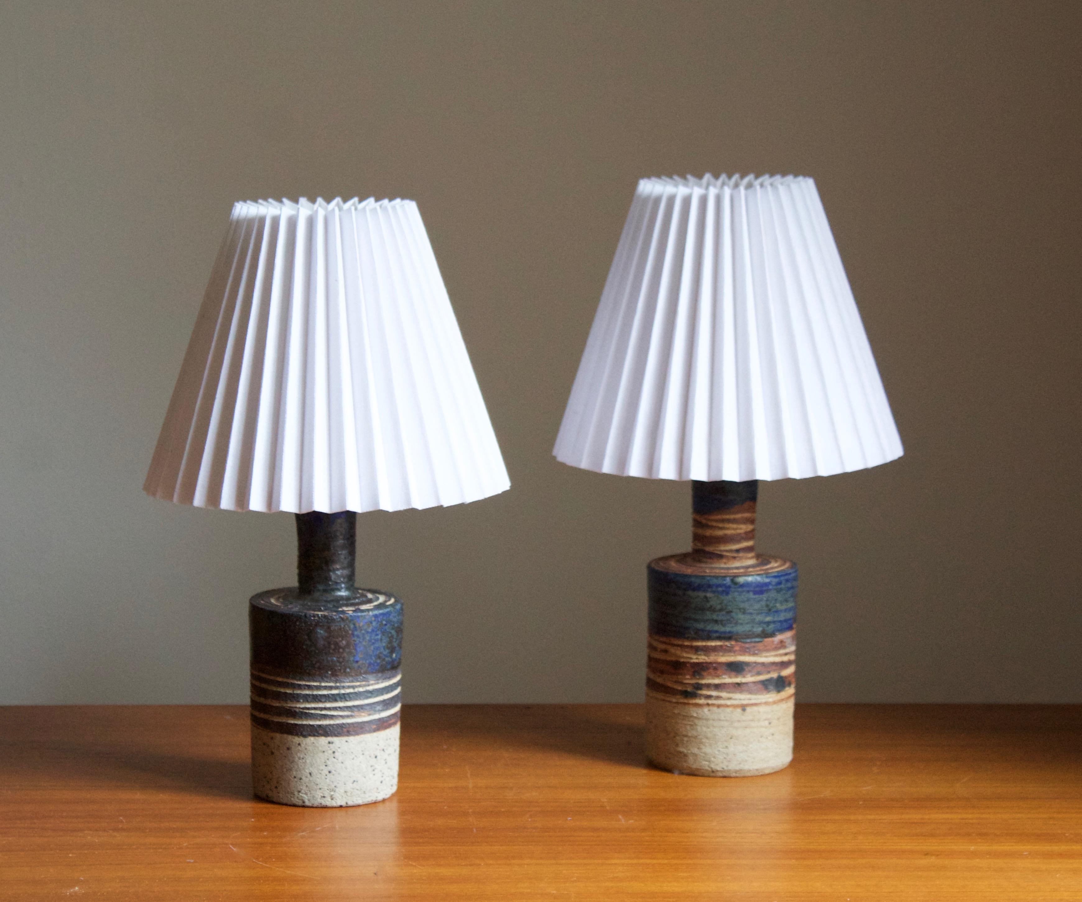 A pair of table lamps. Produced and designed by Tue Poulsen, Denmark, 1960s. Underside of base signed.

Sold without lampshade. Stated dimensions exclude lampshade. Height includes socket. One lamp is slightly less tell, stated dimensions are of the