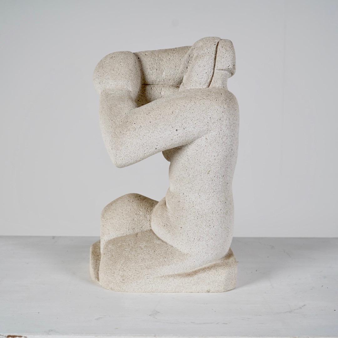 A rare sculpture done in the style Henri Gaudier-Brzeska's seated woman. 

Made from Tuff which is a type of rock made of volcanic ash, you see it used more frequently with mid 20th century lamps, this is the first sculpture I've seen where Tuff