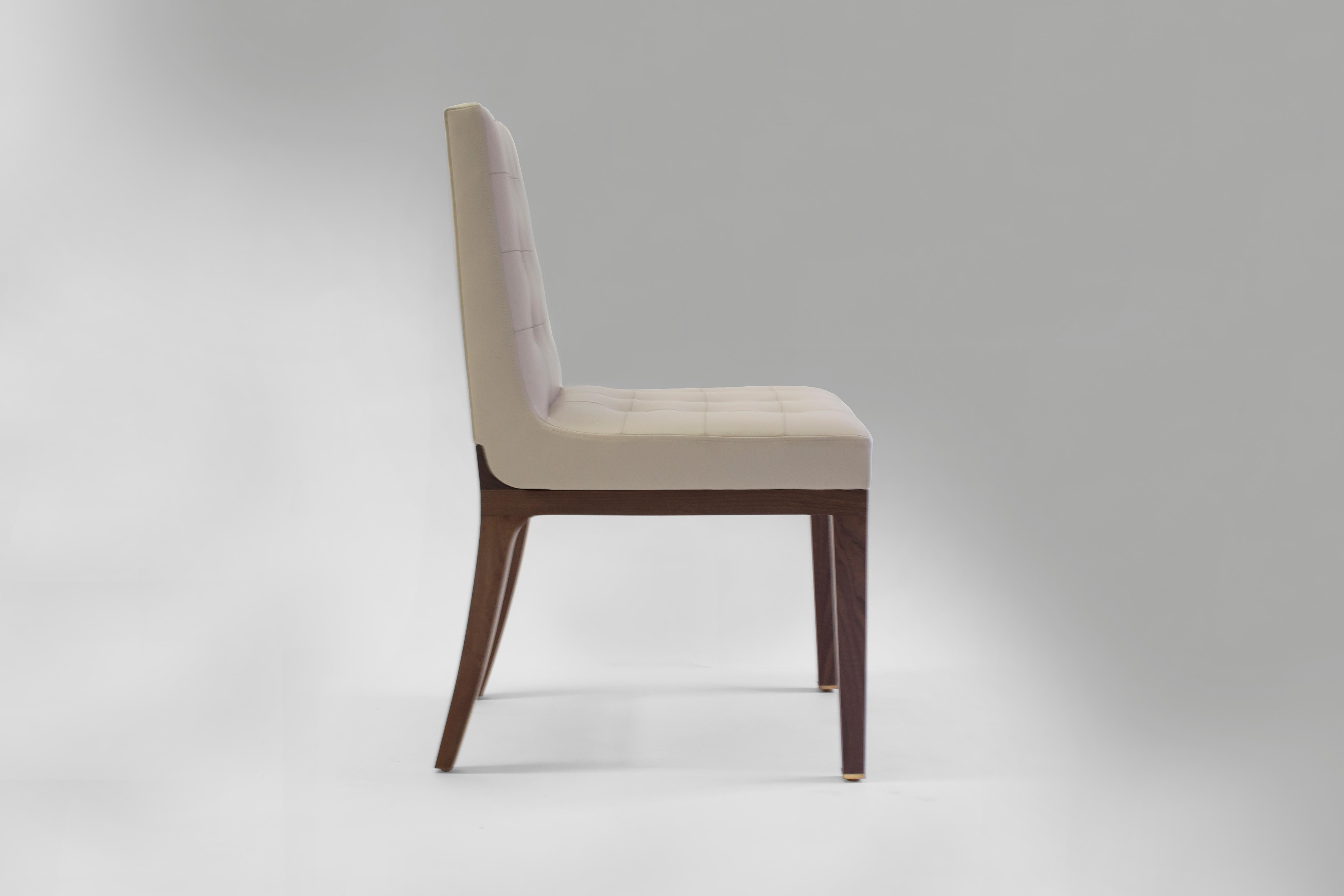 The Corbin side chair can be used as a dining chair, desk chair or an occasional chair - currently covered in tan leather with bisquit tufting on inside back with hand stitching in each tuft. Wood frame and legs made and finished in medium oak, also