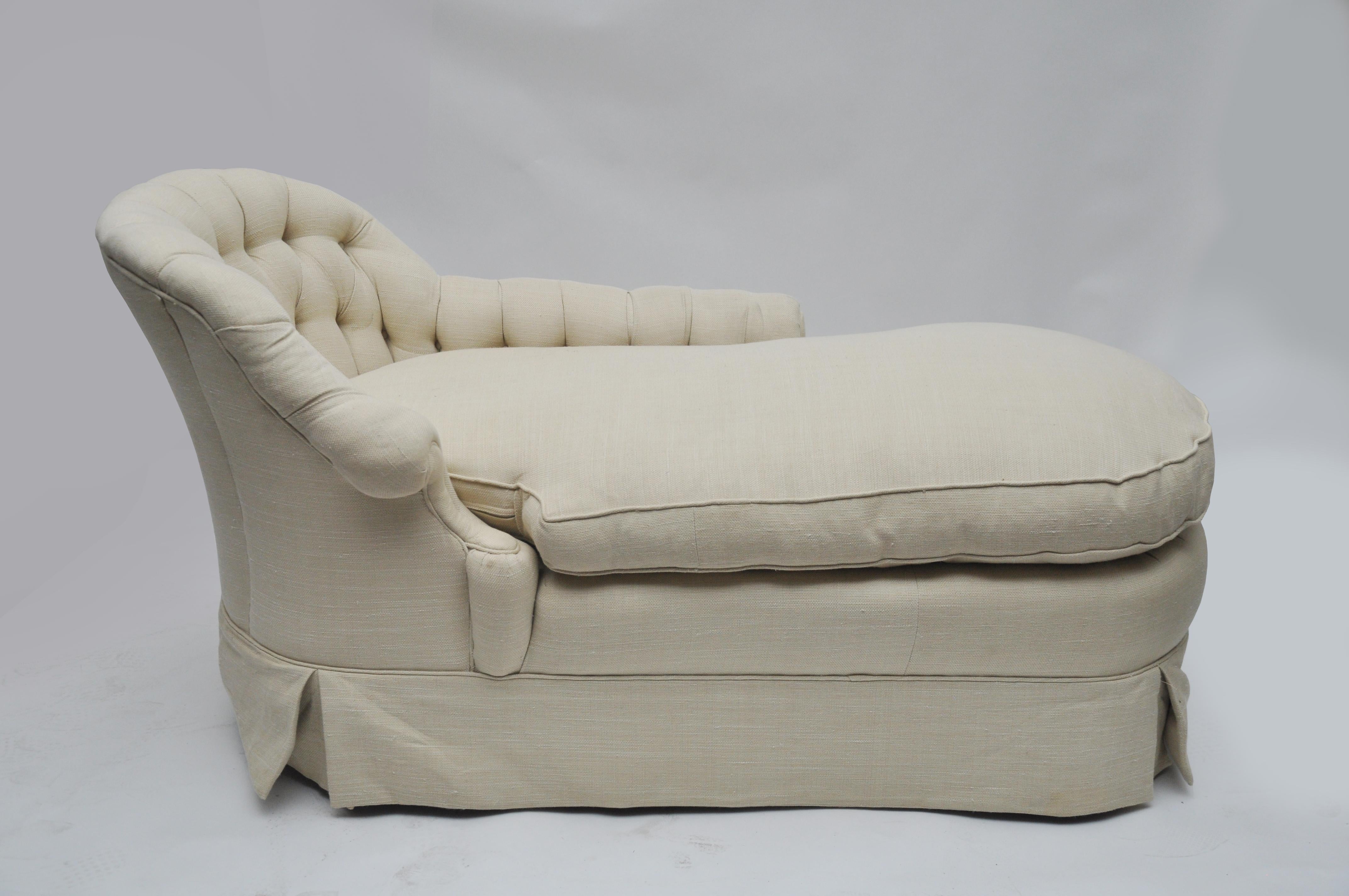 Piece is a smaller skirted chaise. This is not the original fabric. The piece is upholstered in a light cream linen with a down cushion. Seat height is 22